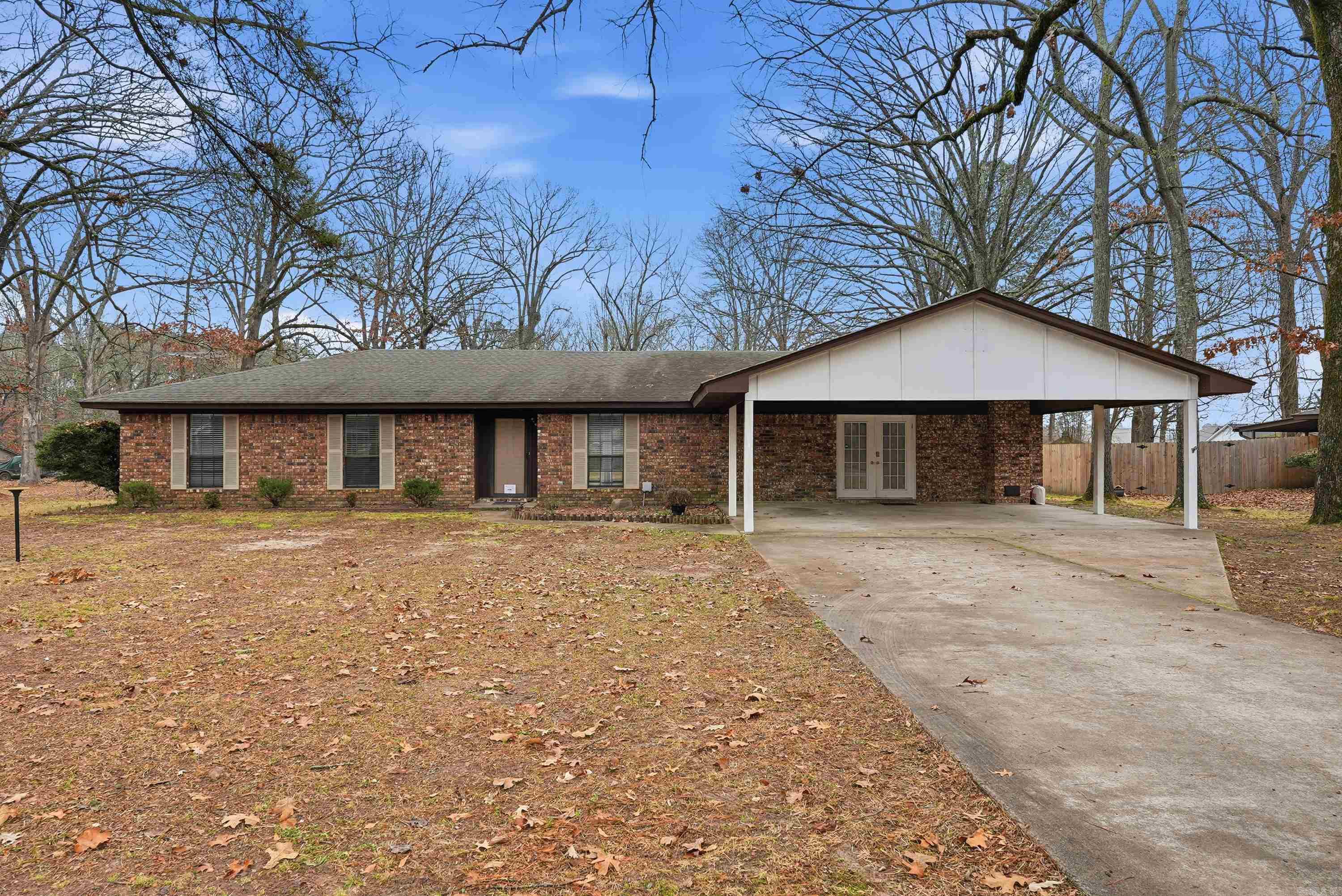 Welcome to this spacious and thoughtfully updated 3-bedroom, 2-bath home, ideally located at the end of a quiet cul-de-sac on 0.50 acres shaded by mature oak trees. With three distinct living spaces, this home offers exceptional flexibility and character rarely found in one property. One living area features a cozy wood-burning stove and a bay window, perfect for relaxing with a book or morning coffee. The second living space includes a built-in bookcase, ideal for a home office, formal dining room, or den. The third living area truly stands out with tall, vaulted ceilings accented by vintage wooden beams, creating a warm and inviting focal point for entertaining. The home has been updated throughout with LED lighting and waterproof LVP flooring in every room. The kitchen shines with granite countertops, which are also featured in the master and guest bathroom, adding a cohesive, modern touch. Located within short distance to Gandy Elementary and situated in the White Hall School District, this home combines comfort, style, and convenience in a peaceful setting. This home is Rural Development eligible.