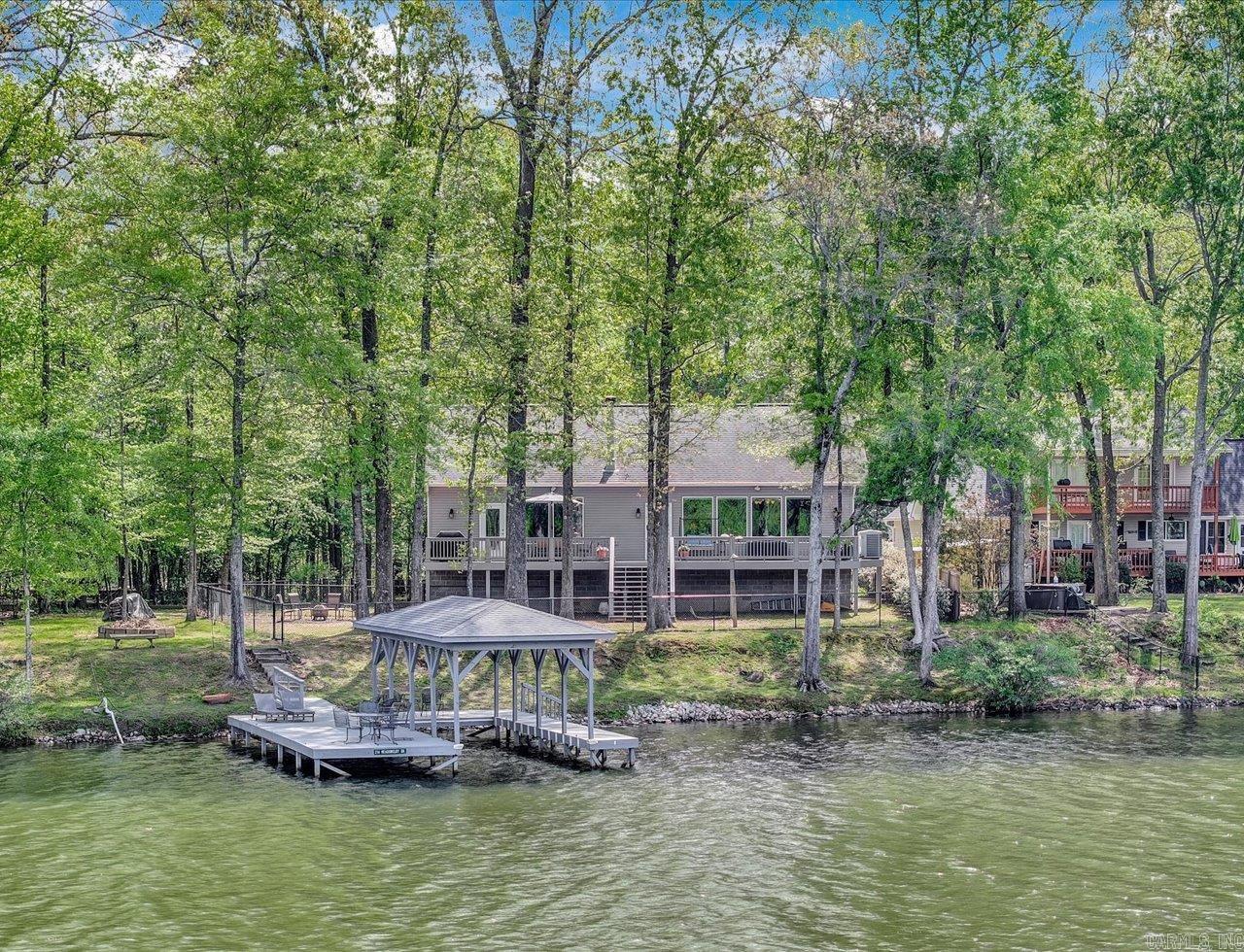 This wonderful lakefront home in the Diamondhead community offers peaceful, serene living with stunning water views and direct lake access. Featuring 3 bedrooms and 2 baths, the open layout is filled with natural light and designed for comfort. A private covered boat slip makes lake days effortless, while the quiet setting creates the perfect retreat. Enjoy the best of lake life with the added bonus of golf and community amenities just moments away along with the Lakeside School System.