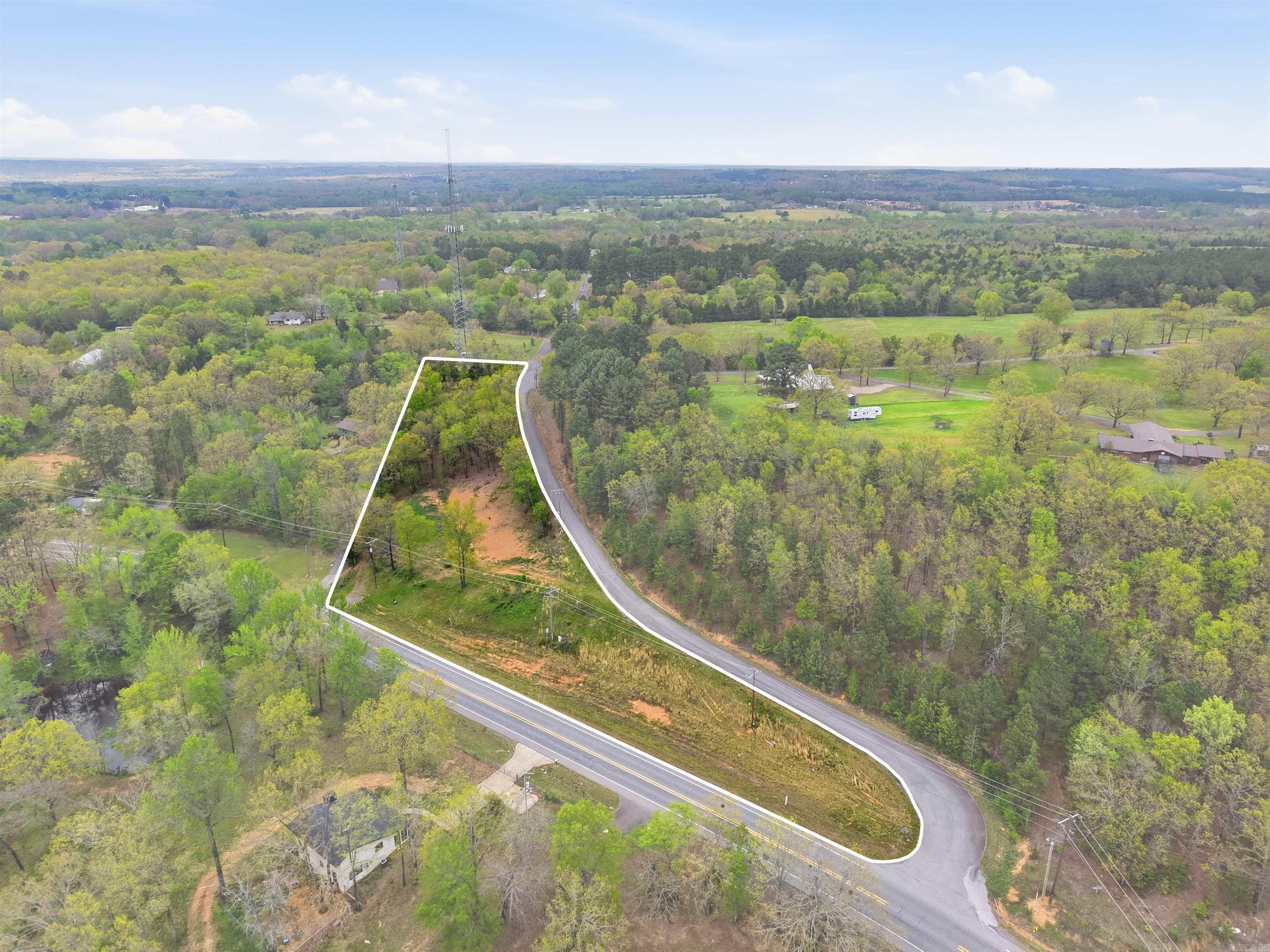 Fantastic development opportunity located just ¼ mile from Wooster Elementary School! This 2.48-acre corner lot offers convenience, accessibility, and flexibility for a variety of residential uses. All major dirt work has been completed — the property is build-ready and can accommodate up to three homes, or two homes plus a shop. Featuring dual access points with an asphalt apron off Hwy 285 and secondary access from McMillen Rd, this lot combines visibility with easy entry. Full city utilities (water and sewer) are available at the site. Ideal for a small residential development, custom home site, or builder investment. Don’t miss your chance to own a turnkey parcel in one of Wooster’s most desirable areas!  Call today for more details or to schedule a property viewing.