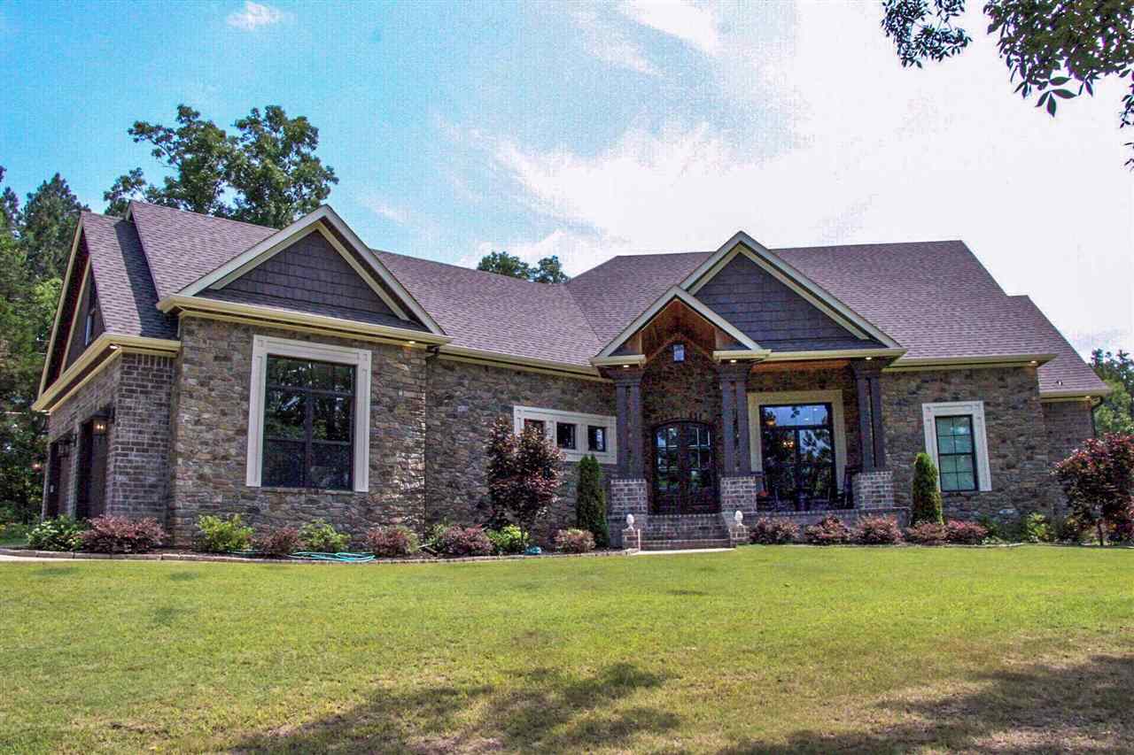 This beautiful custom built, 3BR/2.5BA, open floor plan home sits on approx 2 acres and has all the extra amenities. The master suite is accessible thru the spacious laundry room and has a free standing tub and custom tiled shower. The kitchen is a cooks dream...double wall ovens, gas cooktop, stainless appliances, coffee bar and a walk in pantry with lots of storage. The home offers an office, playroom, bonus/media room and a huge covered porch with a fireplace that overlooks the wooded lot.