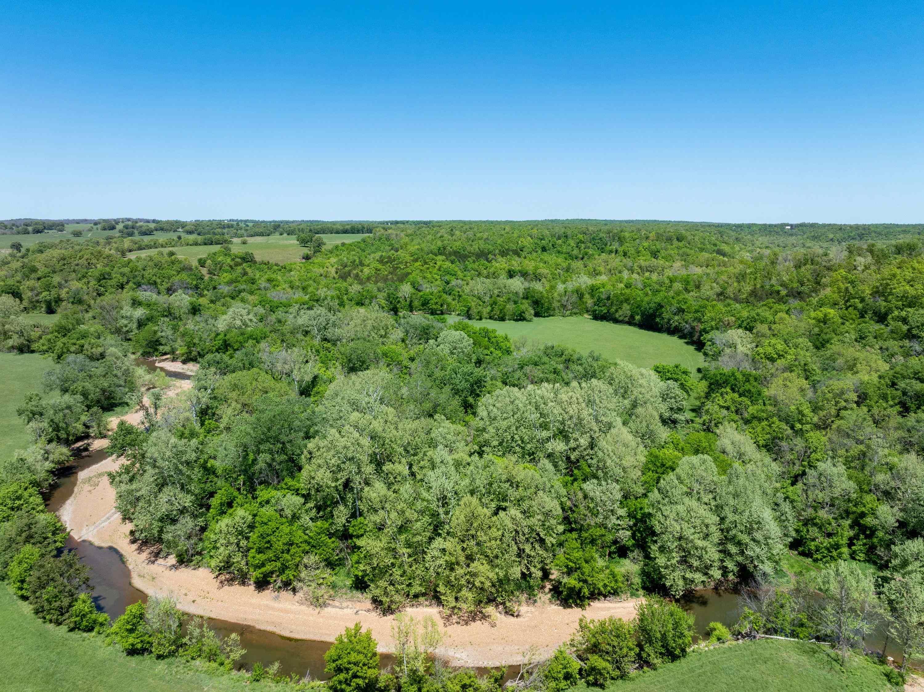 294 +/- Acres with Strawberry River Frontage – Sharp County, Arkansas Discover the ultimate Ozark recreational property just outside Evening Shade, Arkansas. This 294 +/- acre tract offers a rare blend of hunting land, river frontage, trails, and build sites, perfect for year-round enjoyment. Accessed directly from Highway 167 by a private gravel drive you own, the property opens to a field with a well and equipment shed, making it an ideal cabin or home site. The land features a mix of open pastures, mature timber, established trails, and food plots, creating excellent habitat for whitetail deer and turkey. A winding creek system runs throughout, with scenic crossings and trails alongside the water. The highlight is Strawberry River frontage, complete with a sandbar and easy access—perfect for fishing, kayaking, and relaxing in the summer. With multiple elevated areas offering beautiful Ozark views, this property is ideal for a private hunting retreat, family getaway, or investment property. If you’ve been looking for Arkansas land for sale with river, hunting, and seclusion—yet close to town—this is it. Call today to schedule your private tour!