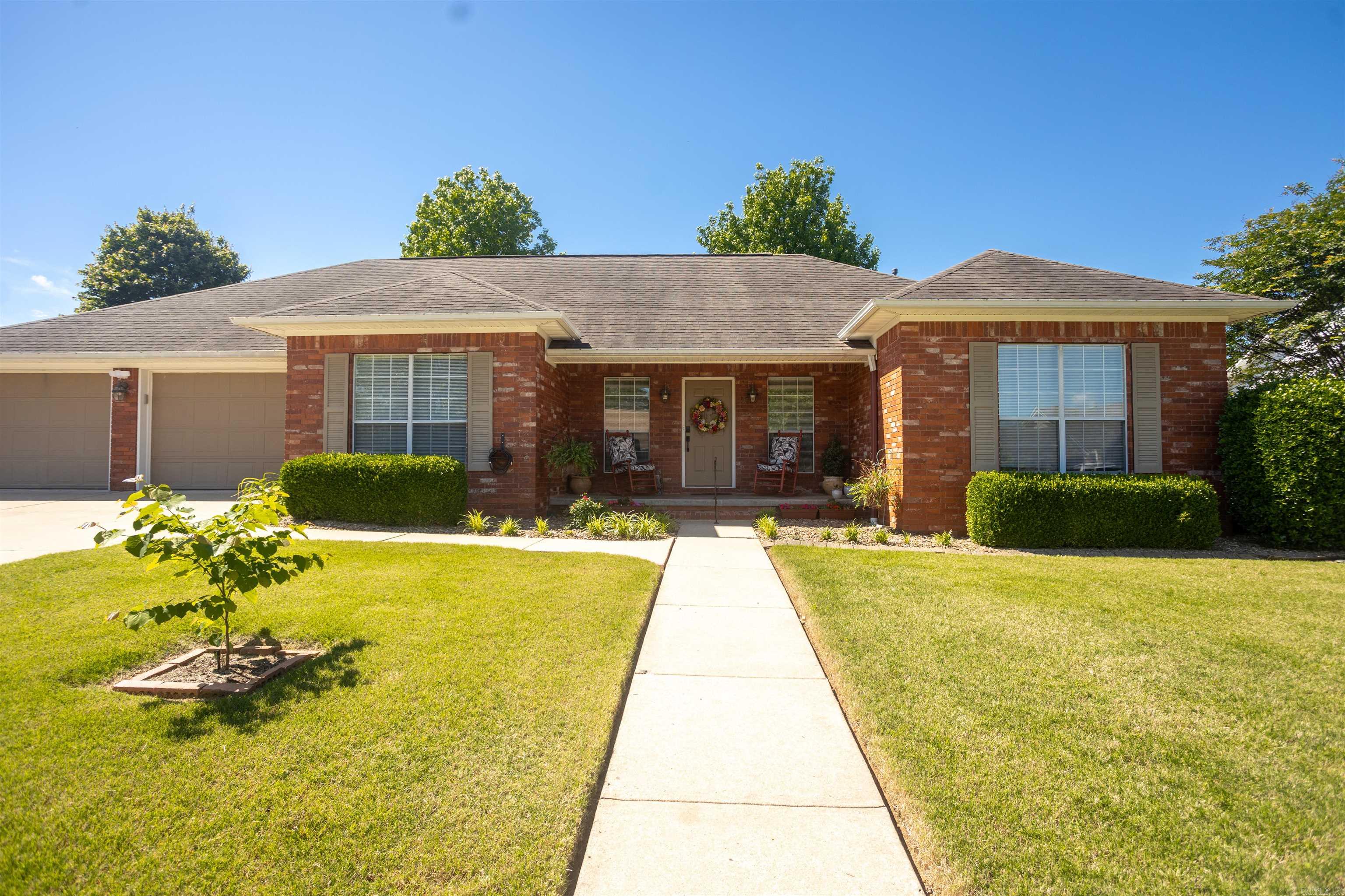 Situated in a quiet, highly desirable Russellville neighborhood within the Sequoyah School District, this classic brick home offers just over 3,000 square feet of beautifully designed, open-concept living space. The layout is incredibly functional and built for easy entertaining. The main living room centers around a gas log fireplace and flows into a spacious kitchen featuring Corian countertops, a large offset island, and built-in oven. With 4 bedrooms, there’s plenty of room to spread out. One of the standout features of this floor plan is the secondary living area—whether you want a dedicated game room, a home office, or a 2nd family room, the space easily adapts to fit your needs. Out back, the home transitions into a private, low-maintenance retreat. The landscaped yard features artificial turf, allowing you to skip the mowing and head straight to the covered patio or fire pit. The property also includes a detached workshop/shed with a wide roll-up door. Brick construction, an adaptable floor plan, and a backyard designed for relaxing rather than working. Reach out today to schedule a private tour!