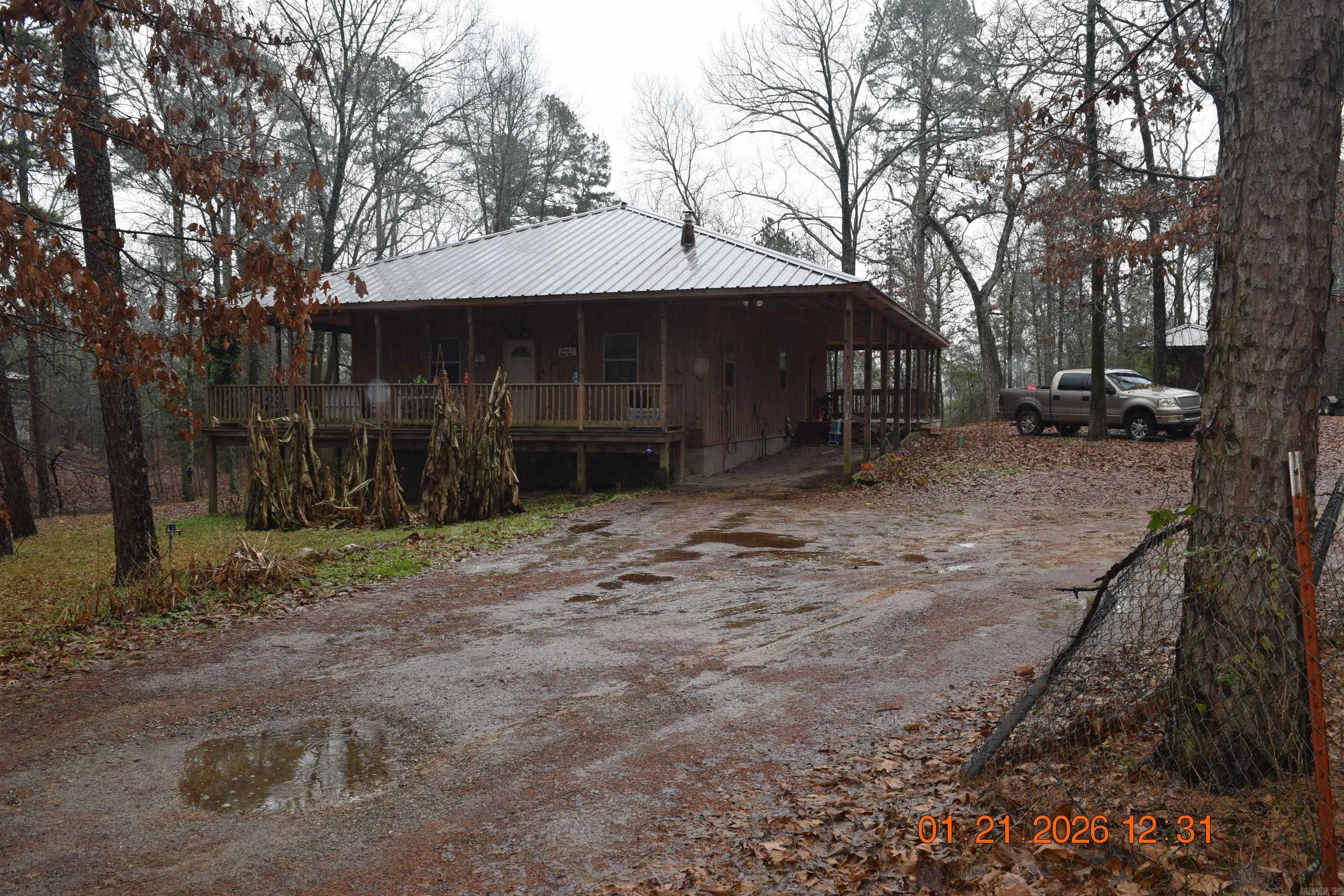 2-bedroom, 2-bath home offering approximately 1,440 +/- square feet with a 2-car carport, situated on approximately 4 +/- acres, with final acreage to be determined by survey. This property is part of a larger parcel and provides multiple purchase options for buyers seeking additional acreage or living space.  An adjoining approximately 4 +/- acres is also available for purchase and includes a second 2-bedroom, 2-bath home as well as an unfinished tiny home. Buyers may purchase this property individually, purchase the adjoining property separately, or purchase the entire parcel consisting of approximately 8 +/- acres, subject to survey. For information regarding the purchase of the entire parcel, see MLS #26003211   The current tax amount is based on a larger parcel that includes multiple properties. Taxes are expected to be adjusted following the survey and division of the property. All acreage amounts are approximate and subject to survey.