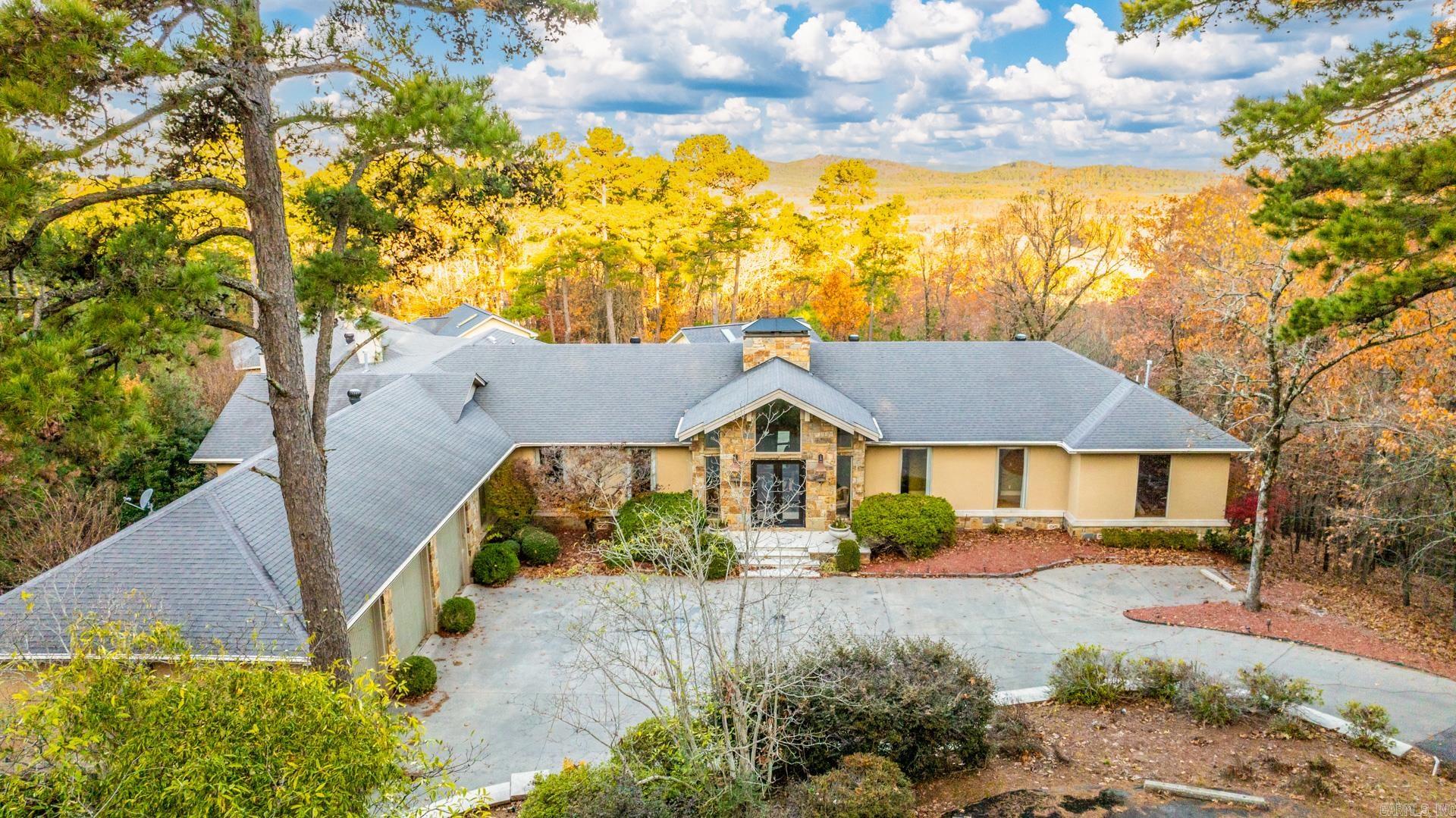Exquisite 1-Level entertainer’s dream on 6 gated acres in Beau Vue, w/ pool, veranda, & stunning views.  Pella double doors open to impressive vaulted grand entry w/ large living: flagstone fireplace + spacious box-ceiling dining. Skylit kitchen: breakfast bar, walk-in pantry, +window-wrapped breakfast.  Outside: enjoy your pool, courtyard that was featured in Arkansas Times, +2 buildings: a skylit pool house w/ wet bar +bonus spa house w/ oven, beverage cooler, & walk-in shower.   Private primary includes hearth sitting, updated bath, dual closets, and veranda access. Don’t miss office, guest suite balcony, 7-car garage, storm shelter, and backup generator.