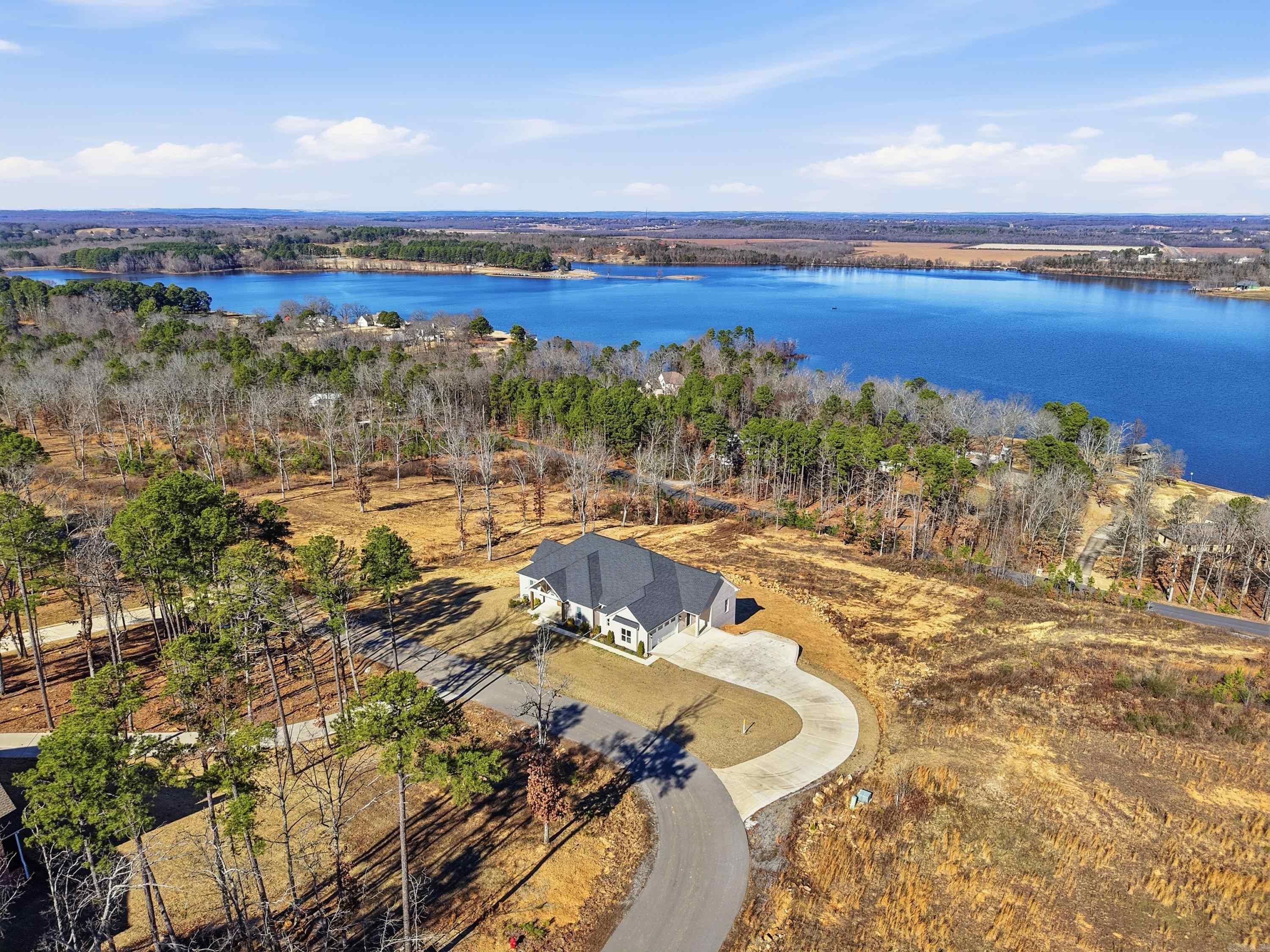 Welcome to this beautifully designed custom-built home, offering the perfect blend of comfort, luxury, and natural beauty. Situated with breathtaking views of Beaver Fork Lake. This 4-bedroom, 3-bathroom home features an open-concept layout, a spacious kitchen, and a cozy living area, all designed with high-end finishes. The expansive master suite provides a serene sanctuary with lake views, while the additional bedrooms are perfect for family or guests. Enjoy extra living space with a versatile bonus area in the finished basement, offering endless possibilities as a home theater, gym, or recreation room. Step outside to your private oasis where you can relax on the patio or deck, soaking in the tranquil surroundings and stunning lake views. This property is perfect for those who appreciate nature, luxury, and the convenience. Don’t miss the chance to make this incredible home your own!