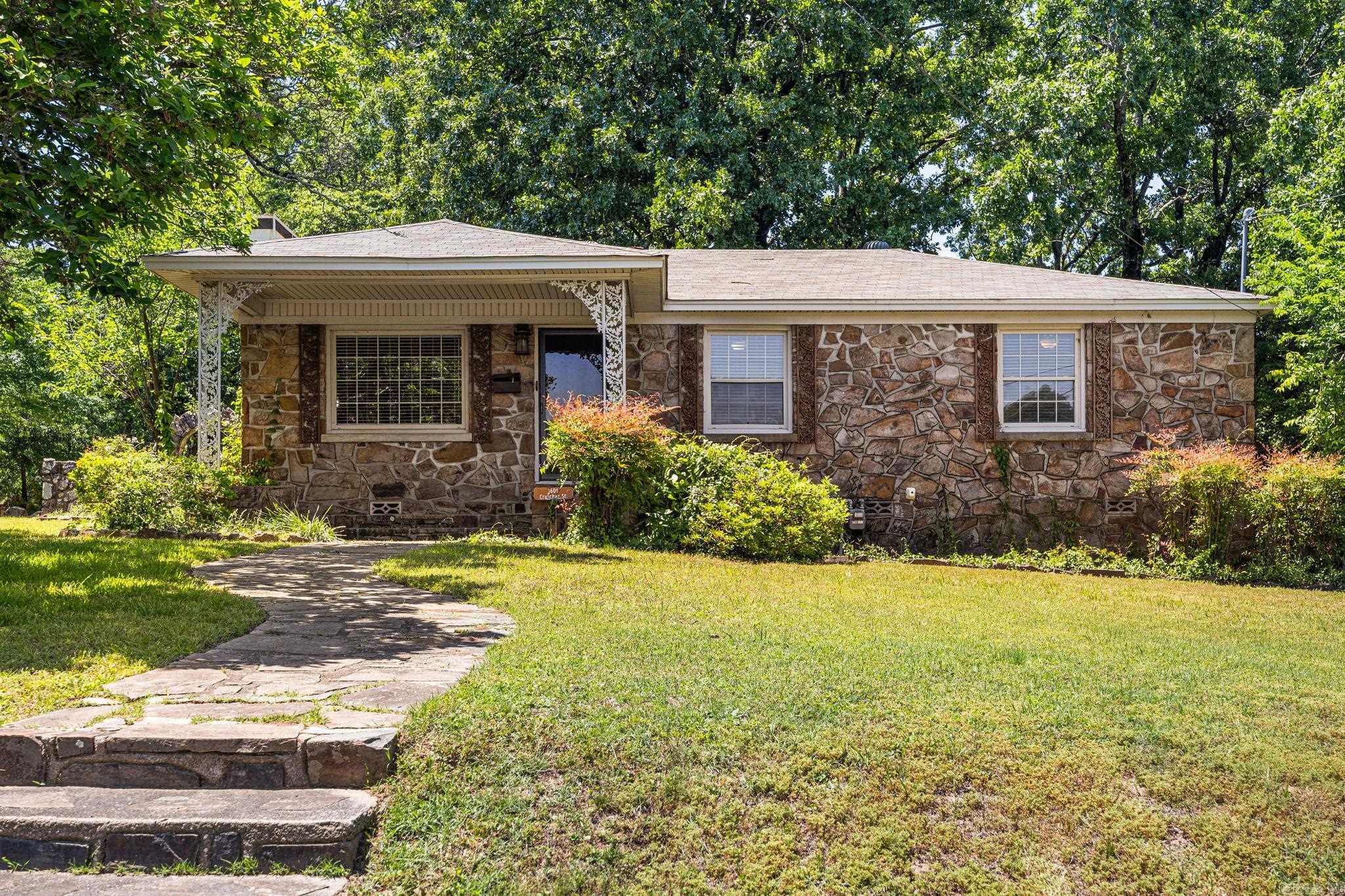 Charming 1946 homestead filled with cottage-style character on a spacious .66-acre corner lot! This unique property features 4 bedrooms and 2 full baths with warm, inviting living spaces throughout. The cozy living room opens to a formal dining area, while the kitchen offers timeless charm with beautiful wood cabinetry. A flexible bonus room is ideal for an office, playroom, hobby space, or second living area. Outside, enjoy a greenhouse with electricity, pergola-covered cookout area with concrete picnic table, garden space, storm shelter, and extra parking. The property also includes a bunkhouse/storage building with electricity and a 2-car carport with additional storage. A rare opportunity offering charm, versatility, outdoor living, and endless possibilities for homeowners seeking comfort, functionality, and room to grow comfortably.