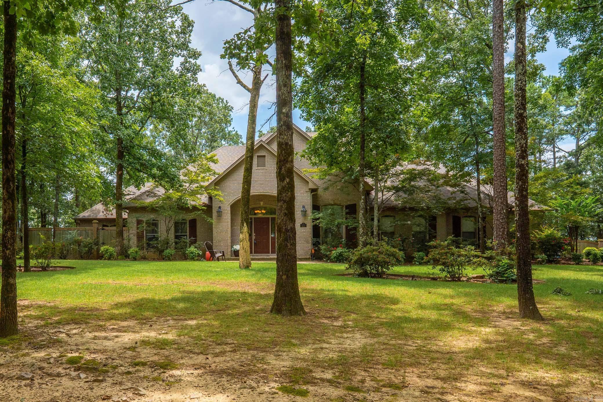 Wonderful Dogwood Estates property with 6 bedrooms, 4 1/2 baths, 3 living areas, nestled on 3.25 acres of scenic beauty in Conway! The beautiful living room with fireplace, formal dining room & sunroom create a warm, inviting atmosphere with abundant natural light & access to the outdoor living areas. The kitchen is a chef’s dream complete with stainless steel appliances, double ovens, gas range, and two expansive islands offering both function and flow for entertaining. This spacious home offers 5 generously sized bedrooms on the main level each w/large closets. The primary suite has tray ceiling, fireplace & large bathroom w/double sinks, walk-in shower & separate tub. 6th bedroom & full bath upstairs alongside a versatile bonus room with kitchenette/wet bar perfect for a media space, game room, or playroom.   Outside enjoy the spacious deck & screened-in porch offering breathtaking views of the surrounding area. The home also features a large three-car garage with a workshop area.