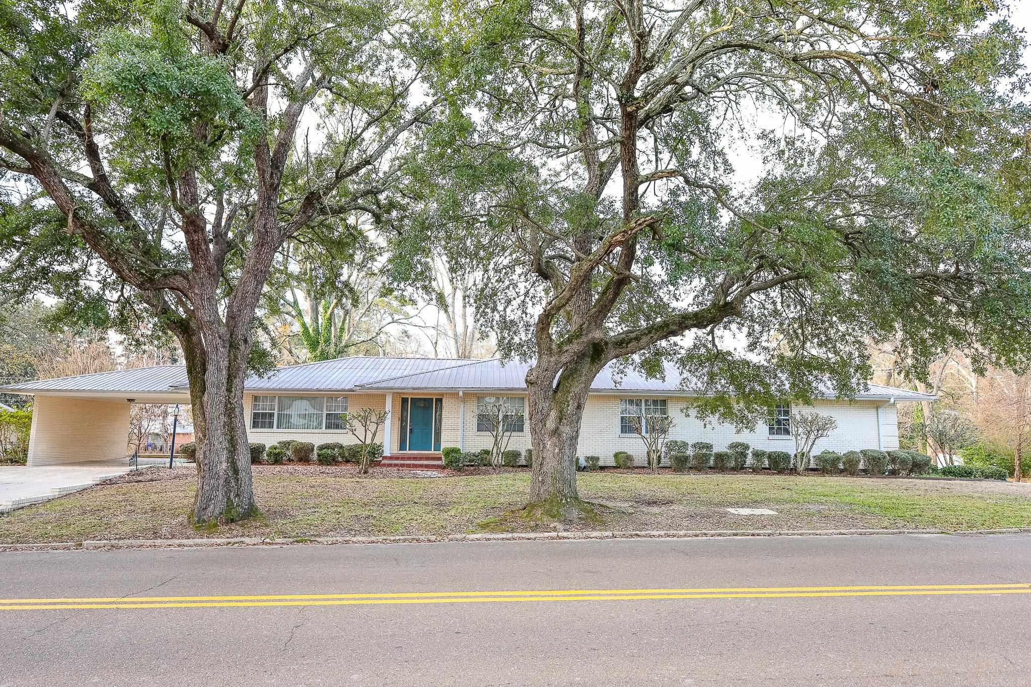 This spacious and versatile home offers 4 bedrooms and 4 full bathrooms on the main level, providing comfortable one-level living with room to spread out.  The walkout basement with a separate drive adds incredible flexibility, featuring a full apartment complete with kitchen, laundry, one bedroom, and one full bath. The basement also includes an additional living area and another full bathroom for even more usable space. And if you’d rather not take the stairs, simply use the elevator for easy access between levels.  Situated on .80 acres, the property includes a large workshop plus a separate heated and cooled workout room, perfect for hobbies, fitness, or extra storage.  A rare opportunity offering convenience, functionality, and flexibility, perfect for multi-generational living, income potential, or everyday comfort.  See attached floorplan sketch for square footage measurements.