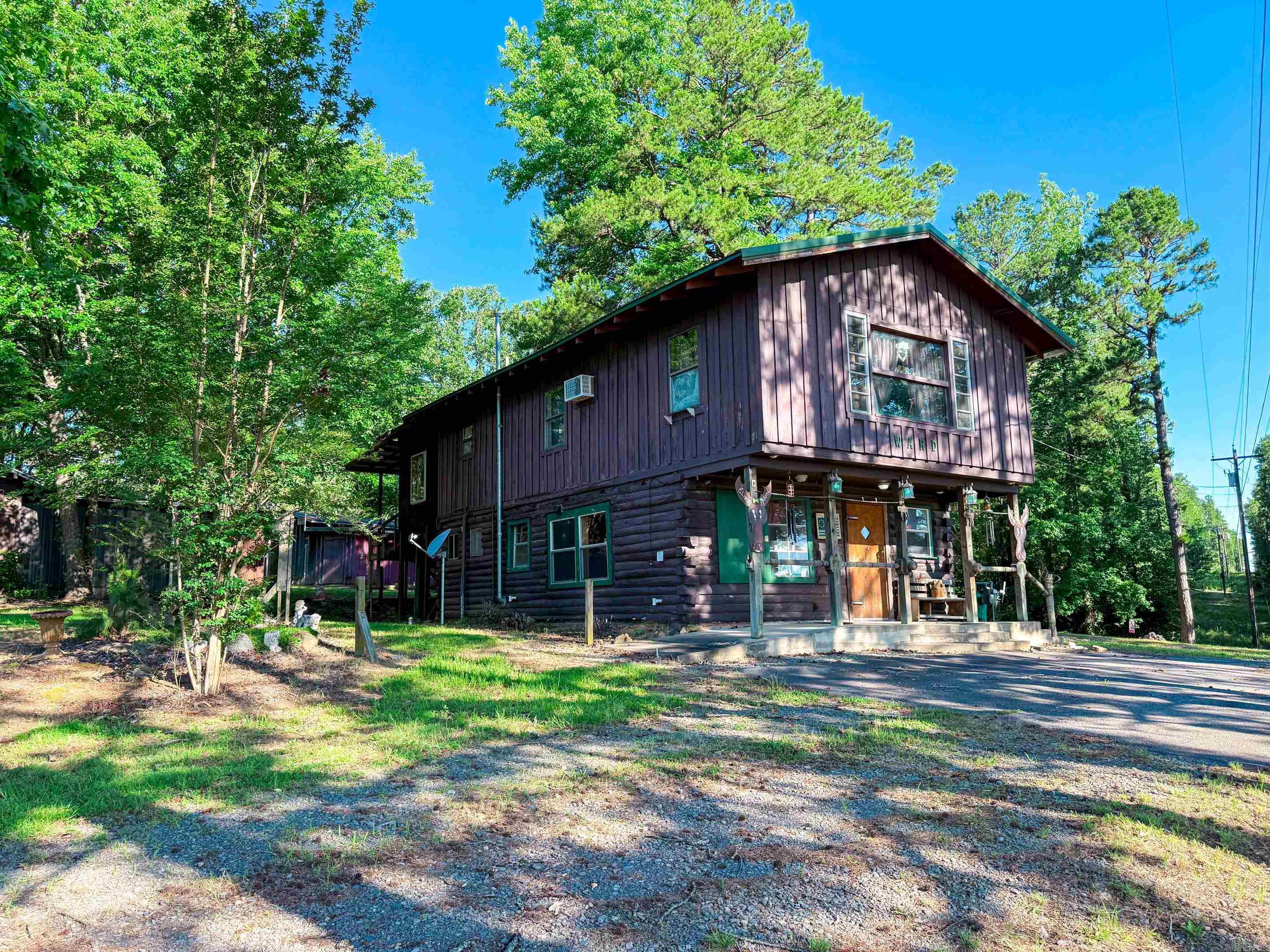 Escape to the country with this unique 2 story cottage nestled on 5 acres! The upper level offers a comfortable living with a spacious living area, kitchen, dining space, 1 bedroom with full bathroom, pantry & a wood burning stove. The lower level features a completely separate studio style unit that is ready for your finishing touches. New appliances including a stove, washer and dryer are already in place. This unit offers potential for guests, rental income or additional living space. Outside, you'll find plenty of room for hobbies & storage. Multiple outbuildings include a 20x30 building, 20x40 building, a 28x30 building and a multi car lean-to. Buildings also include electricity. A storm cellar adds additional peace of mind. Located just 10 minutes from the Choctaw Park entrance of Greers Ferry Lake this versatile property offers endless possibilities. Agents see remarks