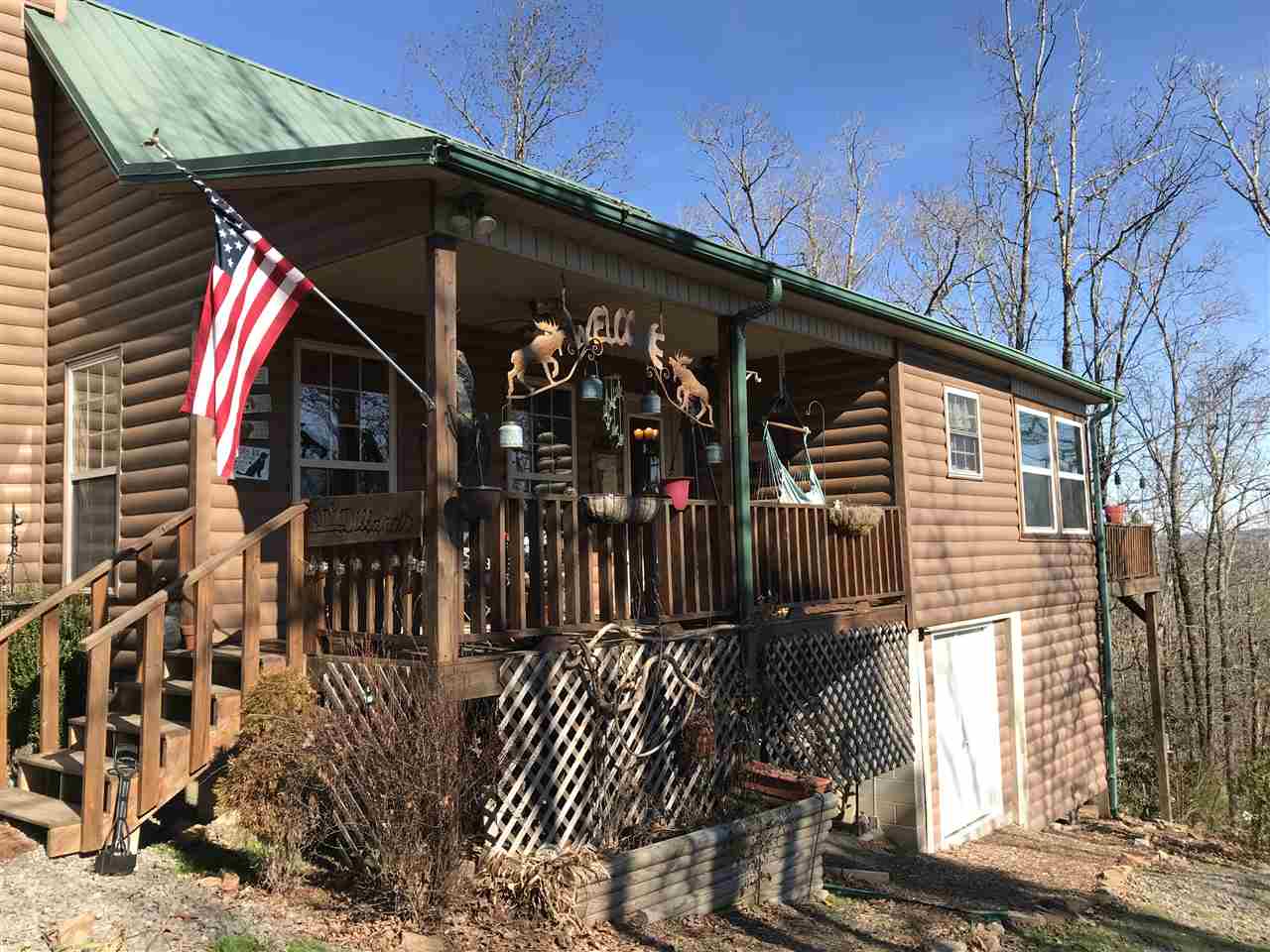 TURN KEY!Beautiful 2 story cabin privately nestled off Scenic Hwy AR-16 with gated entry on approx 23 acres just minutes from Clinton, Greers Ferry Lake, & Fairfield Bay Resort! The great room cathedral ceiling has a gorgeous Iron Works chandelier above a native stone wood burning fireplace. It has a master loft bedroom & en suite bath, large sun-room & deck, private office, greenhouse, gardens, stone outdoor fireplace, pergola, & detached carport w/storage bldg. 10 ac have web wire fencing for dogs. NICE!