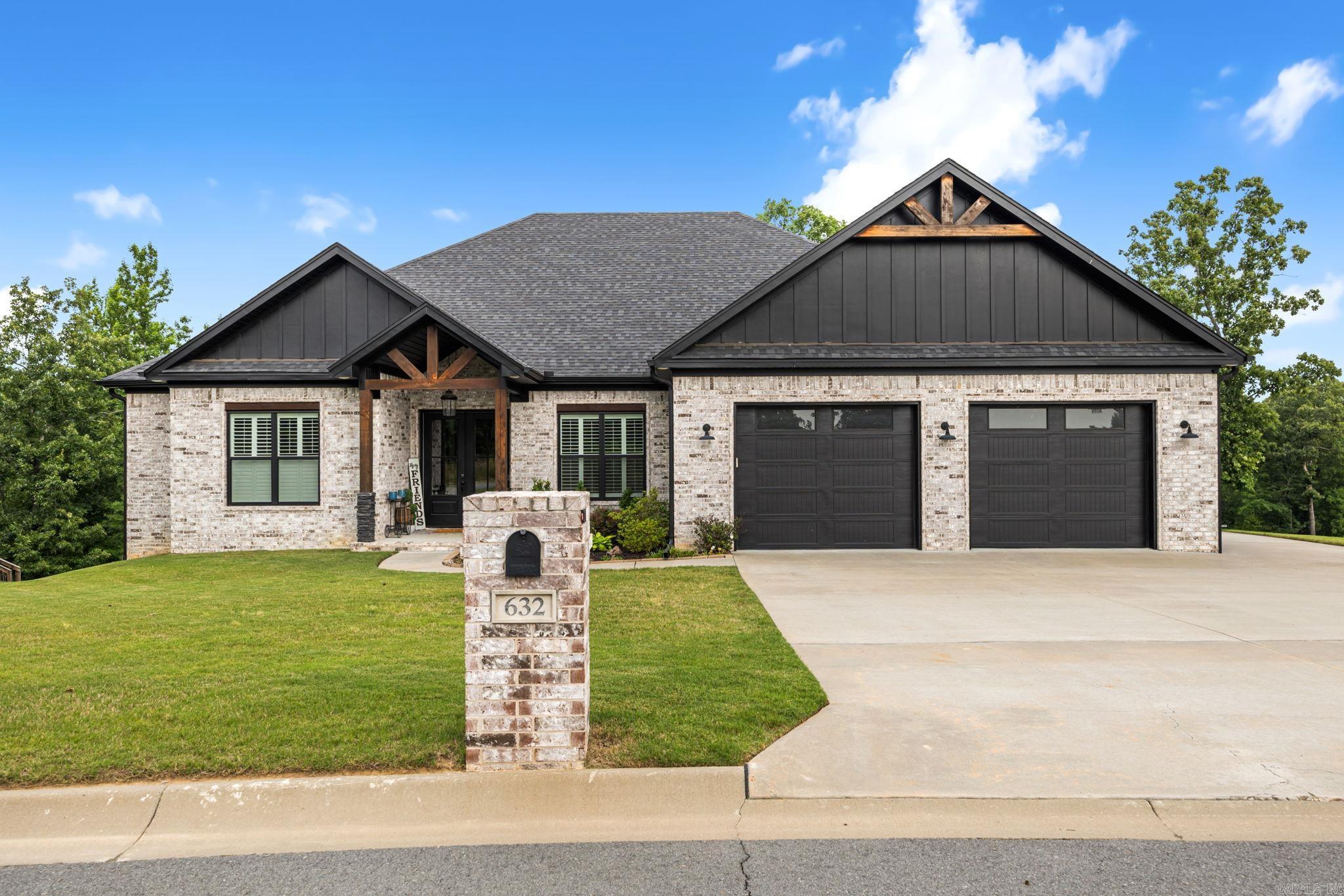 Stunning custom-built home that feels better than new, with thoughtful upgrades and exceptional attention to detail throughout. Beautiful curb appeal, double front doors, and 11' entry ceilings make an impressive first impression. Natural light throughout home is showcased with plantation shutters. Just off the entry, a private office features a gorgeous coffered ceiling, while the open living area offers 12' beamed ceilings and an inviting layout designed for everyday living and entertaining. The kitchen features a gas range, built-in refrigerator, spacious island, quartz countertops, white cabinetry, and ample workspace. The main suite is a true retreat with beamed ceilings, double separate vanities, soaking tub, oversized shower with two shower heads plus rain shower, and an incredible closet that connects to the laundry room. Opposite side offers 3 additional bedrooms, including one ensuite, 2 full baths, and its own zoned HVAC. Enjoy the additional 1/2 bath, screened-in porch with built-in storage and granite counter, expanded deck overlooking the creek, oversized garage, walk-up floored attic, tankless water heater, and finished shop with electricity. This one is special.