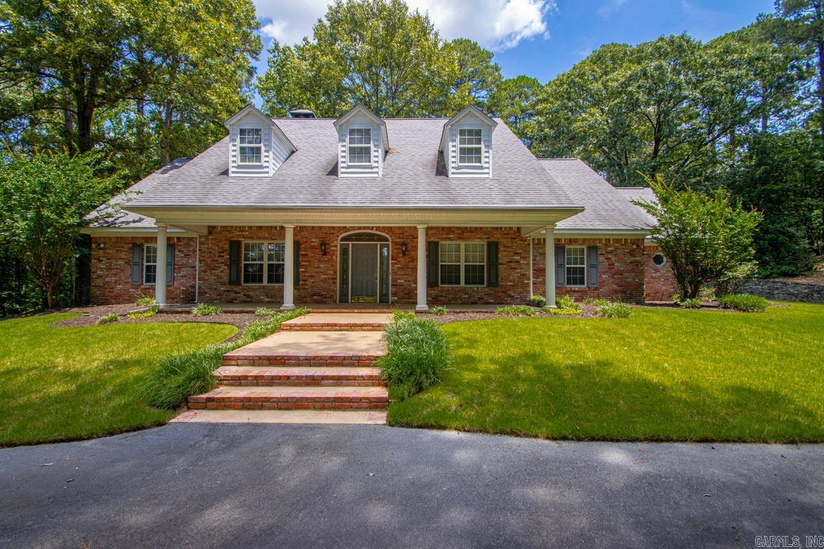 Beautiful estate-style property offering approximately 3,600 square feet of living space on nearly 8 acres. Enjoy the perfect combination of privacy and convenience, located less than a mile from Interstate 30 at Exit 117. The spacious kitchen opens seamlessly into the den, creating an ideal gathering space centered around a cozy fireplace. The formal living room showcases soaring vaulted ceilings and a second fireplace, adding warmth, character, and an impressive sense of scale.  Designed with a desirable split floor plan, the home offers both privacy and functionality. The spacious primary suite serves as a true retreat, featuring two walk-in closets and an adjacent office that is perfect for working from home or a private study.  Constructed at a time when quality and scale were paramount, this impressive estate remains a standout property today. Exceptionally maintained throughout its ownership, the home retains the solid construction, spacious layout, and architectural presence that made it one of the area's most admired residences. A rare opportunity to own a private acreage estate and personalize it to your own style and taste.