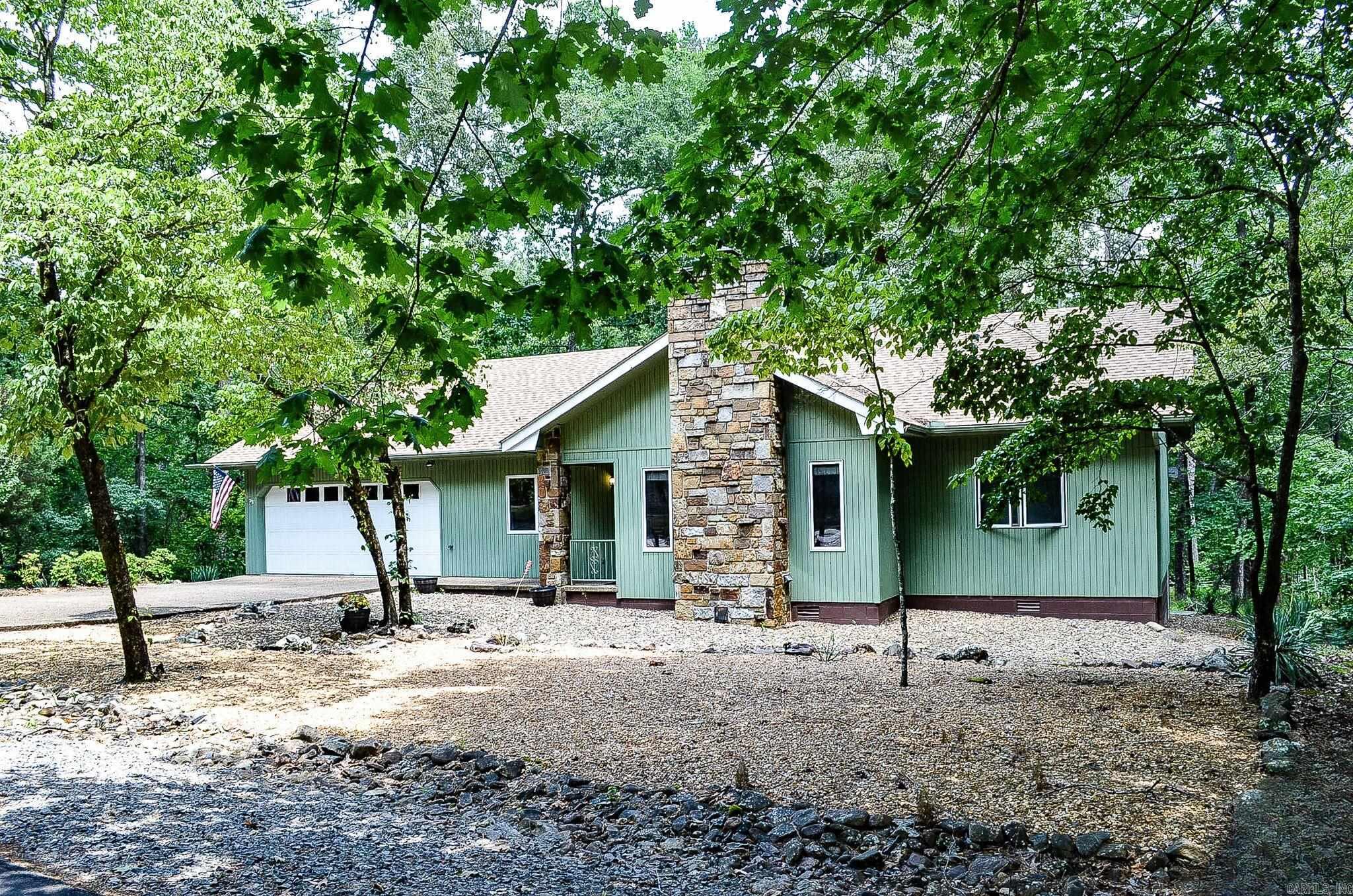 Charming home ready to meet new owner! Located in beautiful Hot Springs Village, this 1576 sf, split plan has 2 bedrooms, plus a bonus room for an additional bedroom, office, or craft room, and 2 bathrooms. Features include: New Roof (2025), Newer Water Heater (2024), Heat Pump Motor Replaced (2025), Granite Countertops in Kitchen, Wood-burning Fireplace with Removable Electric Insert, Fenced Area in Backyard, Easy Maintenance Landscaping, Workbench and Extra Storage in 2-car Garage. The back deck is the perfect place for enjoying nature with your morning coffee or an evening beverage with friends. Welcome home! SEE AGENT REMARKS.