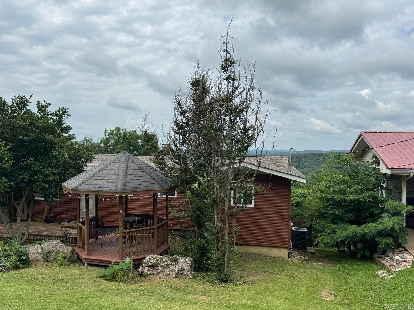 Enjoy breathtaking views from this charming 2-bedroom, 1-bath home situated on approximately 1.5 acres that stretches all the way to the river. The open-concept floor plan features a vaulted ceiling, creating a spacious and inviting atmosphere perfect for everyday living and entertaining. Step outside to the large back deck, where you can relax and take in the outstanding scenery year-round. The fenced backyard offers plenty of space for pets, gardening, or outdoor activities, while the gazebo in the front yard provides a peaceful spot. Additional features include a dedicated laundry room and an extra lot with a garage/shop, offering excellent storage, workspace, or hobby potential.Carport has been enclosed and the space could be an extra bedroom or living area, however you finish it.