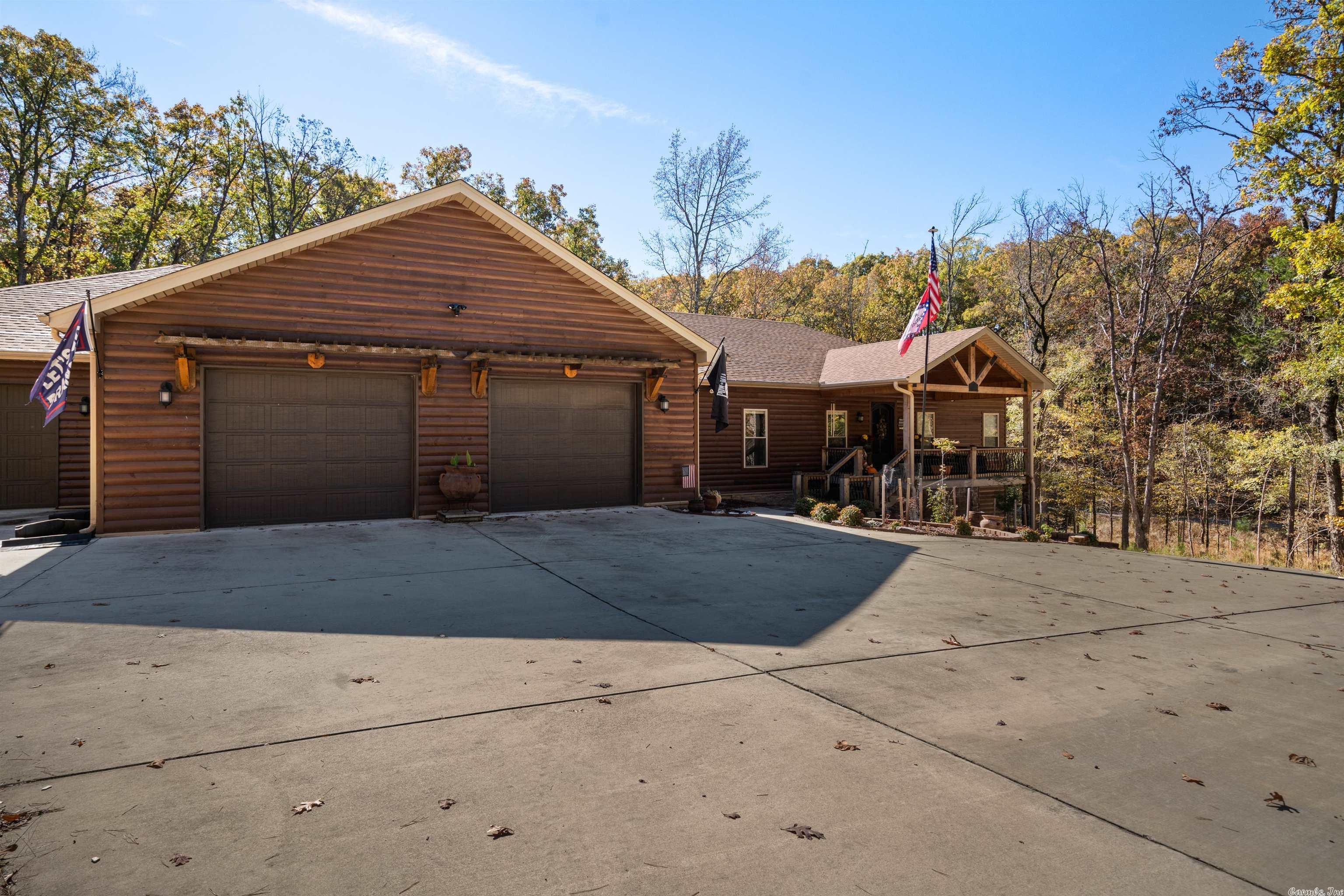 MOUNTAIN  HARBOR  Majestic  custom built  log  home  is situated on 1.26 acres with 3500 sq ft of unexpected amenities that are certain to please. These include the gourmet kitchen, enclosed sunroom,  3 h/a units, quartzite countertops, bamboo flooring, dry bar with built in wine cooler.and 2x6 walls.  Outside features include a greenhouse,  large flagstone patio with two decks,  oversized circle driveway., oversized 3 car garage PLUS a large storage area under the home with garage door entry. Whole house generator 22KW. New roof in 2022. The 6 person hot tub is another extra but there is so much more to see.  A complete is list available on request.Boat slip is $3,000.00 a year and can only transfer if buyer buys the boat currently there.  Seller is willing to sell side by side as well.   The $42.00 is waste water management fee.