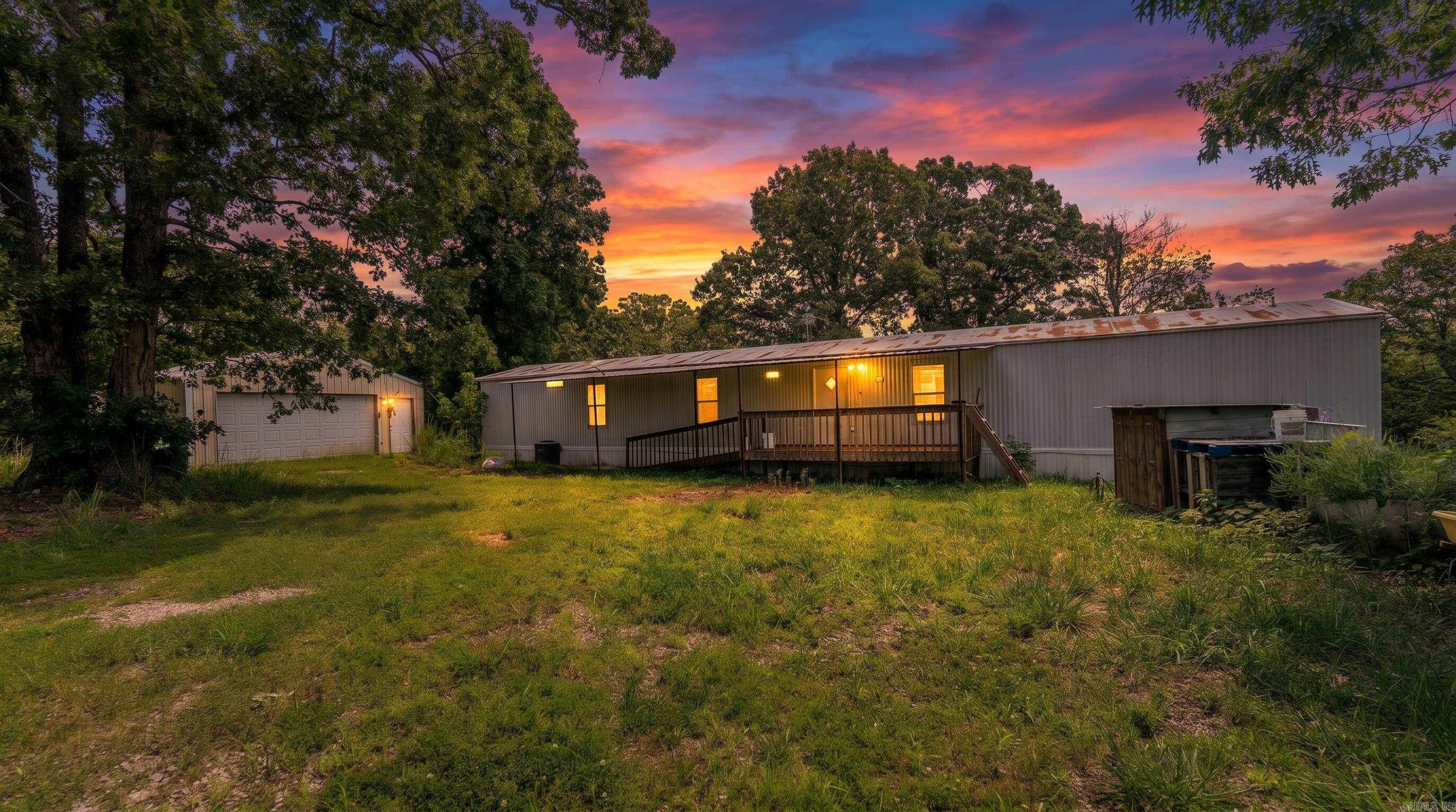 Hunting Property in the Ozarks Escape to the privacy of the Missouri Ozarks with this 40-acre property featuring a 3-bedroom, 2-bathroom single-wide home, abundant wildlife, and excellent recreational opportunities. Located behind a gated entrance and set well back from the road, the property offers the peaceful rural lifestyle many buyers are seeking.  The home features a functional floor plan, private well and septic system, covered front entry with ramp access, and mature shade trees that create an inviting setting. Additional improvements include a small workshop for storage, equipment, or hobbies and a dedicated storm shelter for added peace of mind.  The predominantly wooded acreage provides excellent habitat for deer and other native wildlife, making it an outstanding hunting property or recreational retreat. Two ponds add both scenic appeal and water sources for wildlife. With a gravel driveway, low property taxes, and no visible neighboring homes, this property offers exceptional privacy. Whether you're looking for a full-time residence, hunting getaway, or land investment, this Ozarks property is worth a closer look.