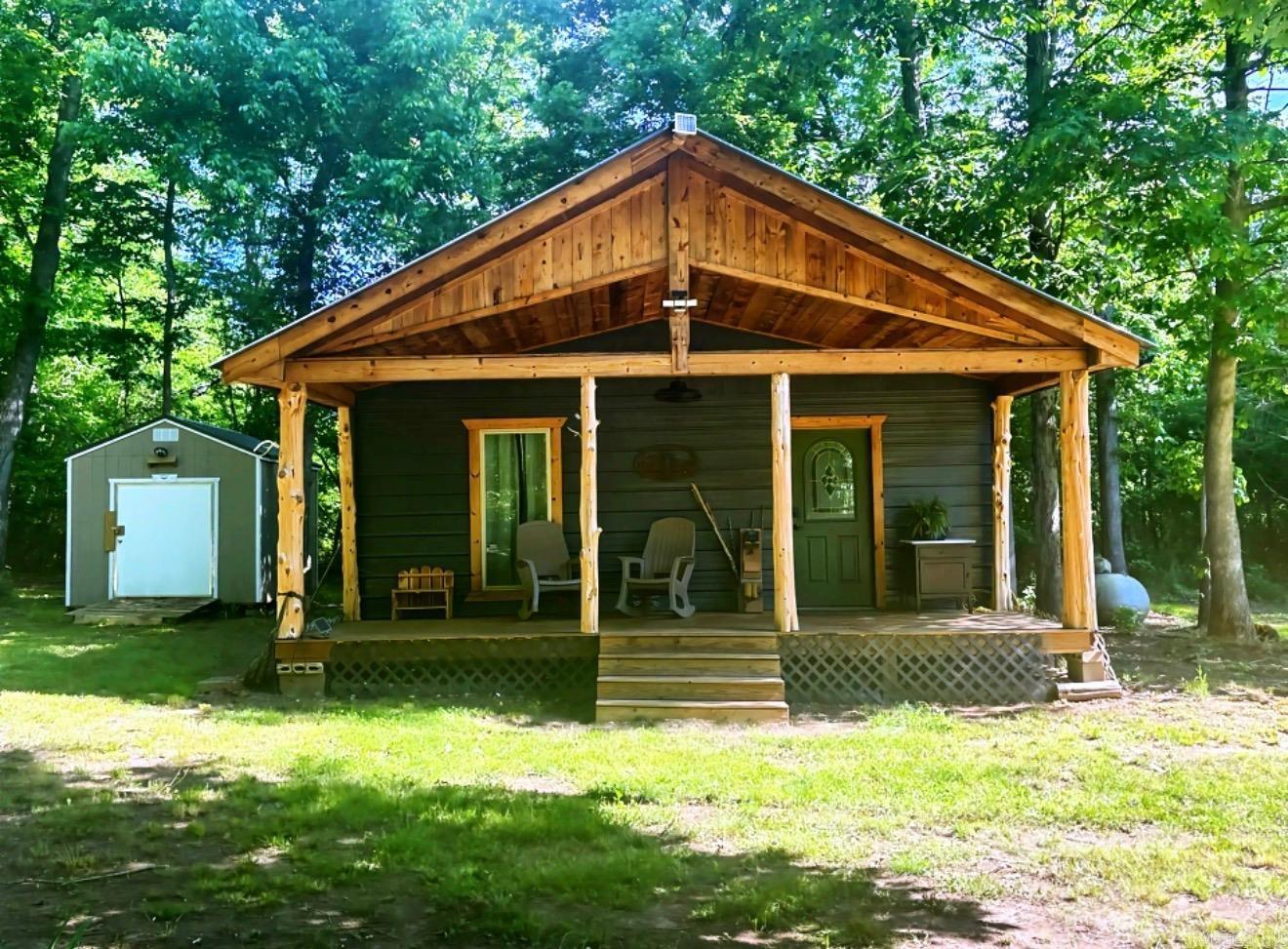 Escape the noise and settle into your own private retreat with this charming off grid- dream cabin tucked away on 40 beautiful wooded acres. Whether you're looking to homestead, hunt, unplug, or create a peaceful getaway, this property offers the perfect blend of comfort and self-sufficiency. The rustic cabin features a front porch, warm wood accents, and a cozy country feel. Designed for independent living, the property includes solar-generated electricity for lighting and a generated water system, making it ideal for off-grid living or sustainable homesteading. Surrounded by mature trees and abundant wildlife, the acreage provides endless opportunities! If you have been dreaming of land to make truly your own, this unique property is ready for its next adventure!