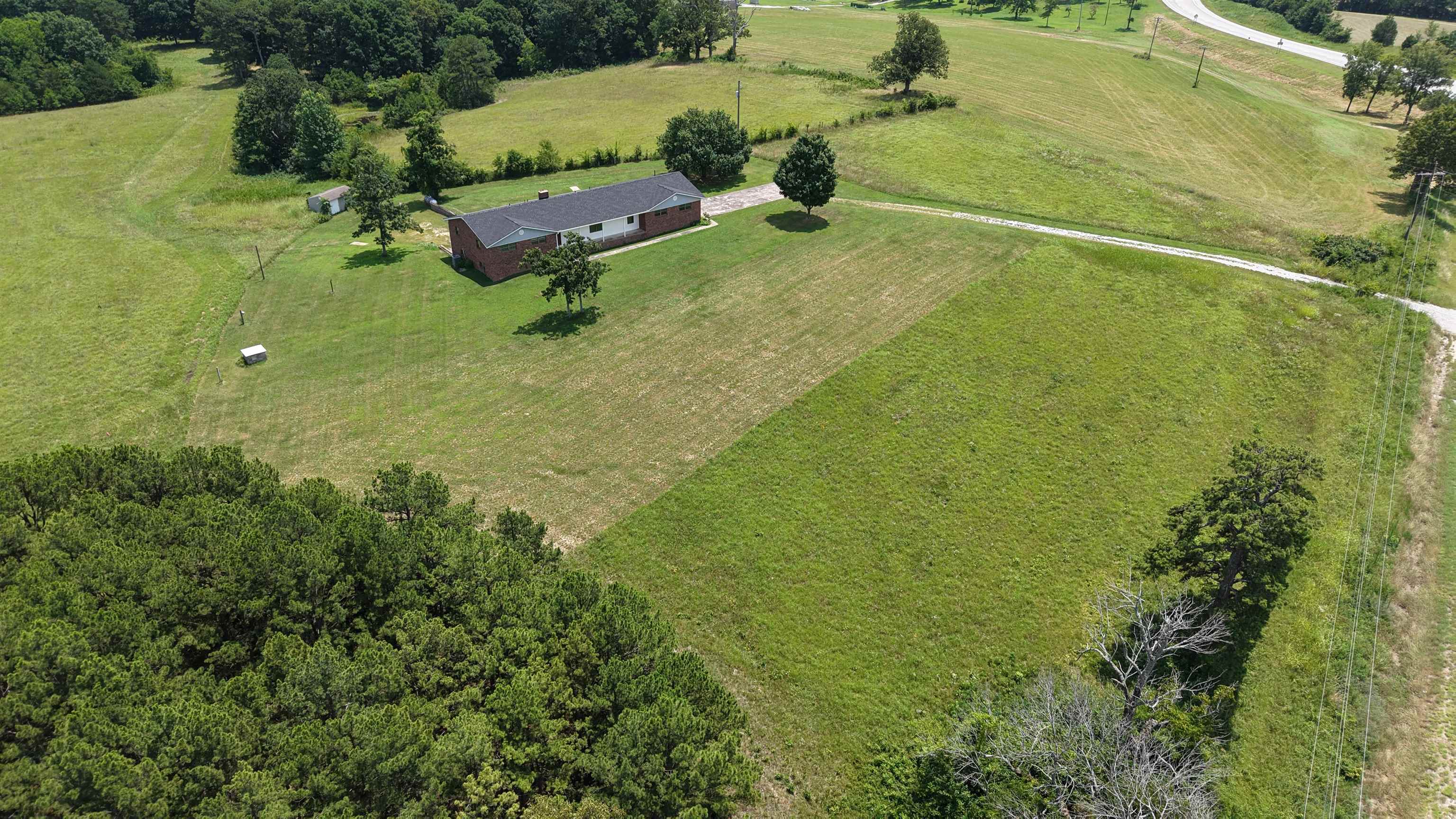 Discover this beautifully renovated 5-bedroom, 4-bathroom brick home on 5 acres in the heart of North Central Arkansas, ideally located between Melbourne and Batesville. Situated on a scenic hilltop, this property offers breathtaking Ozark Mountain views, rural country living, and convenient access to town. This spacious home features 2,161 sq ft on the main level plus a 1,939 sq ft basement, providing ample living space. The main level includes 3 bedrooms, 3 full bathrooms, a large living area, and an open-concept kitchen perfect for entertaining. The partially finished basement adds 2 additional bedrooms, 1 bathroom, and plenty of unfinished space for storage, a workshop, or future expansion. Recent upgrades include a new roof, new HVAC system, and a brand-new back deck—ideal for enjoying the panoramic views and outdoor living. The 5-acre tract offers privacy, room for outdoor activities, and space for gardening, animals, or additional improvements. Additional acreage is available for buyers seeking even more land. This move-in-ready home combines modern updates, acreage, and stunning Ozark scenery for only $329,900.