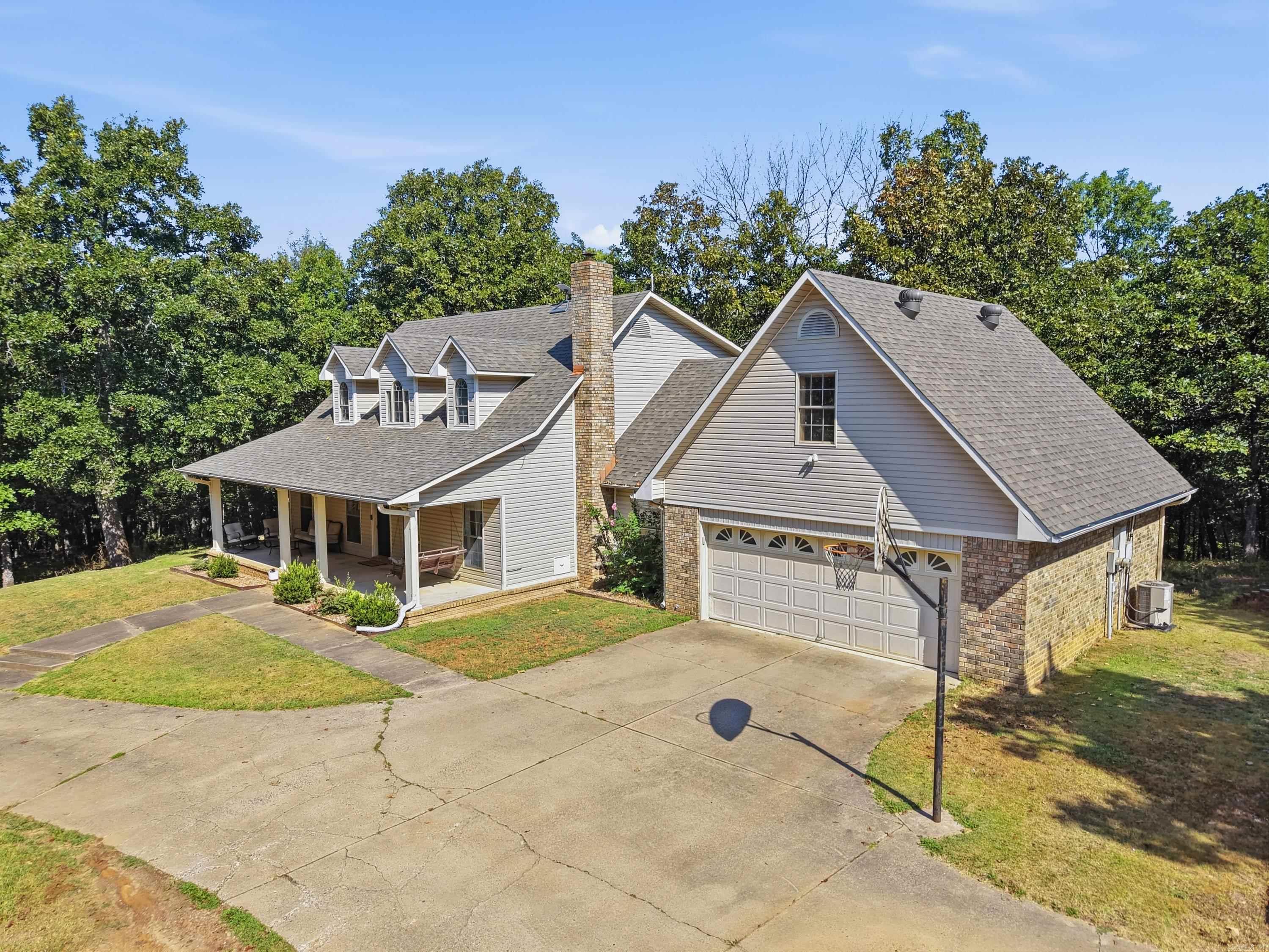 Looking for acreage without giving up modern amenities? This beautiful home offers the perfect mix of privacy, functional, and comfort on 7.6 ac with a large shop in Vilonia!  4 bedrooms, 3.5 bathrooms, 7.6 acres, attached 2 car garage, shop with electricity, quartz countertops, new subway tile backsplash, net kitchen sink and garbage disposal, hardwood with carpet in bedrooms, primary bedroom and bathroom is on the main level, two additional bedrooms and a jack and Jill bath on the second level, and a private 4th bedroom and full bath over the garage. (Accessed through garage) Also has a convenient half bath off the kitchen with great built-ins in the utility room. Updates include new cann and soffit lighting, fresh gravel flooring in the shop, new water, roof replaced in 2023. Has city water with optional well water for outdoor use (no pump installed in well currently) If you've been searching for a home with acreage (and a few deer), a shop, updated finishes, and room to spread out in Central Arkansas this one is for you! Agents see remarks.