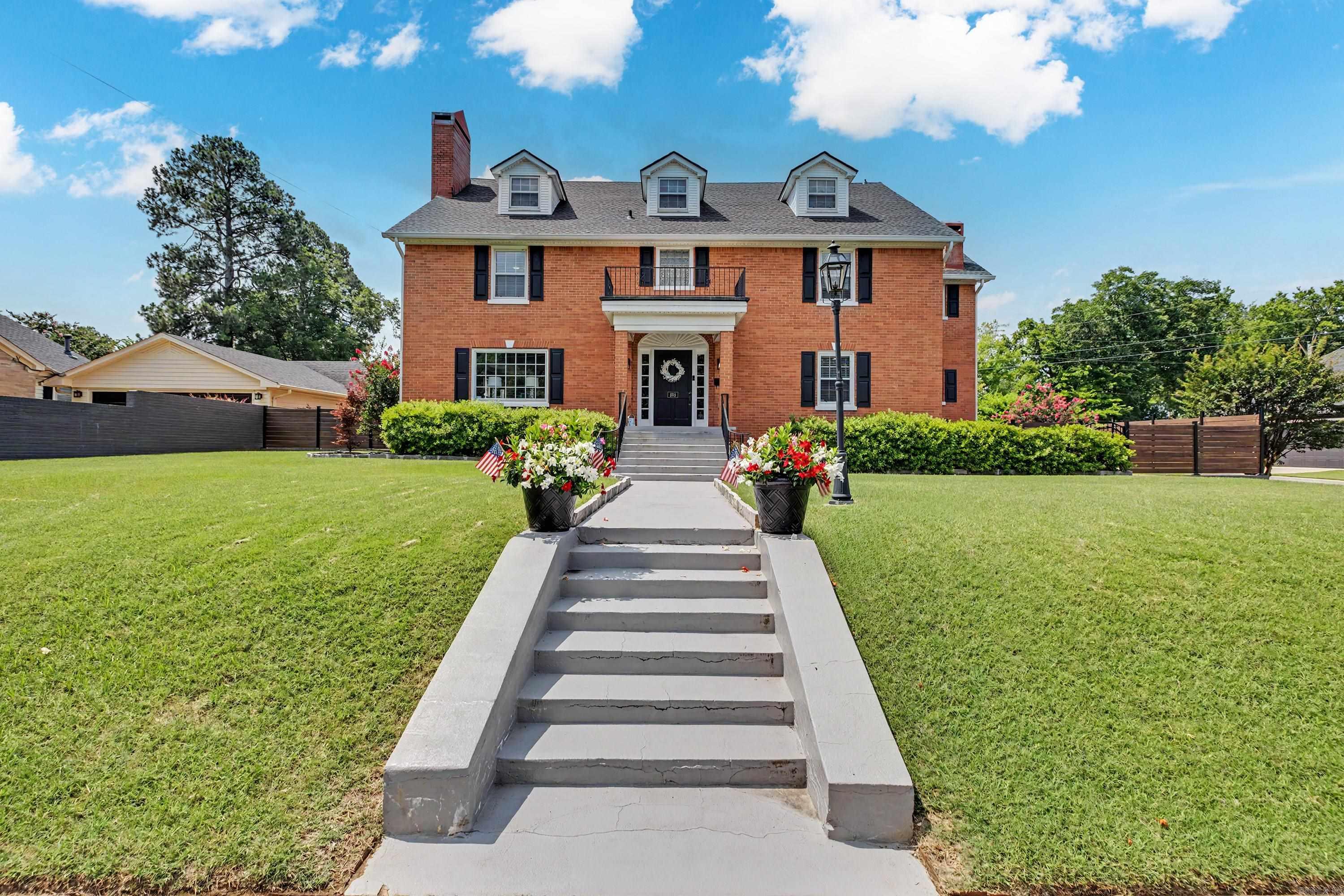 Classic brick 4-bedroom home on a corner lot just minutes from downtown Benton with quick interstate access. The main level includes a formal living room, private office, formal dining room, and an updated kitchen with abundant cabinet and counter space. All four oversized bedrooms are located upstairs, including a spacious primary suite with a remodeled bath featuring a freestanding soaking tub, oversized tiled shower, and double vanity. The third-floor bonus room provides flexible space for a media room, playroom, home gym, or hobby area. Outside, enjoy a covered patio, large backyard, and a 4-car garage with additional driveway parking. With generous room sizes and functional living spaces throughout, this home offers plenty of room to spread out.