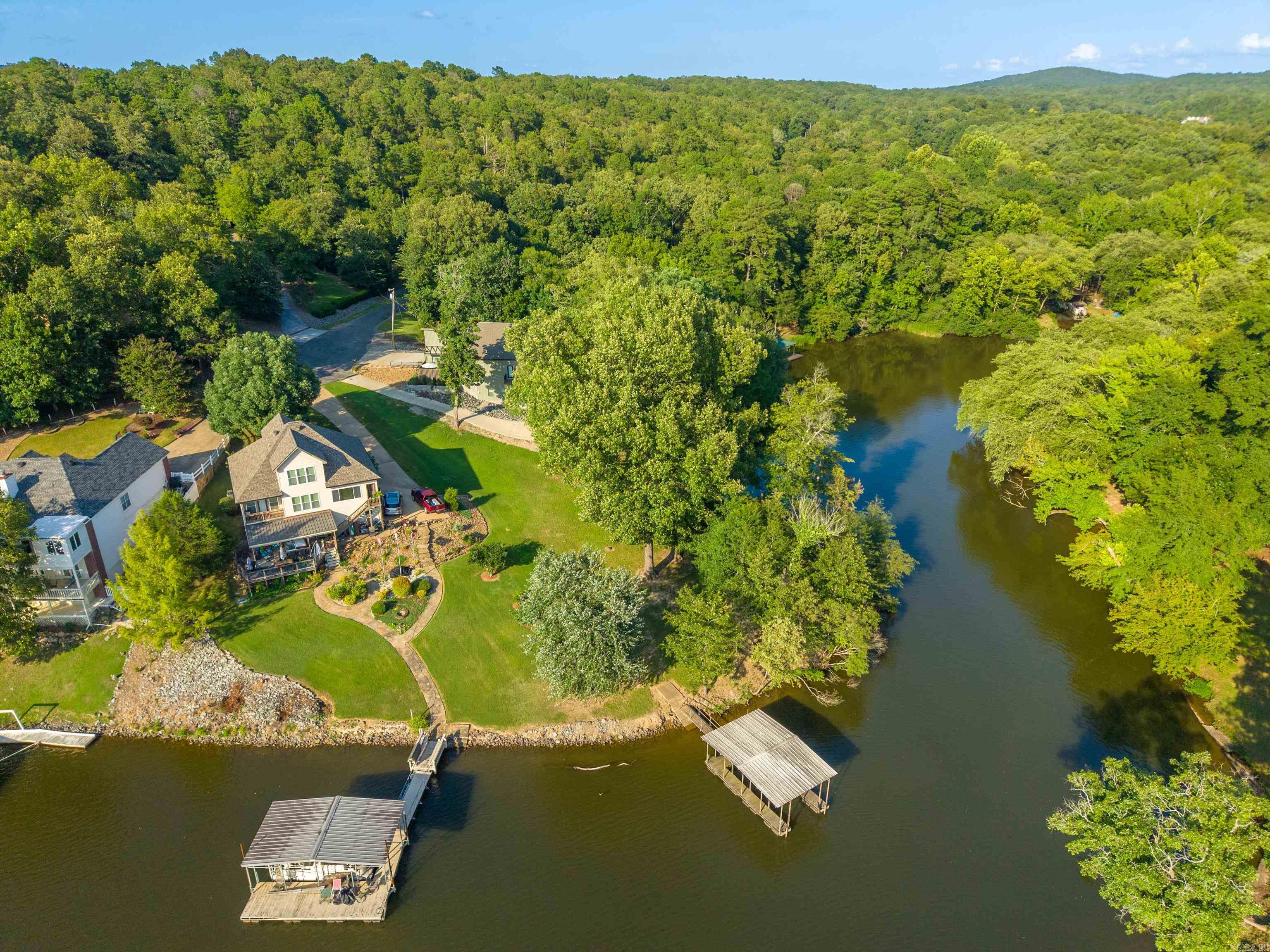 One of Diamondhead’s most desirable lakefront lots is now available! Offering approximately 210 feet of year-round waterfront on Lake Catherine, this exceptional property features breathtaking sunset views, expansive main-channel views, a protected cove, and a private boat dock. Build your dream home, vacation retreat, or investment property in the highly desirable Lakeside School District. Enjoy the Diamondhead lifestyle in this private, amenity-rich community featuring a PGA-sanctioned 18-hole golf course, Olympic-sized swimming pool, clubhouse, fitness center, library, tennis, pickleball and basketball courts, playground, and more. Conveniently located just minutes from Oaklawn Racing Casino Resort, Garvan Woodland Gardens, Lake Catherine State Park, shopping, and dining.