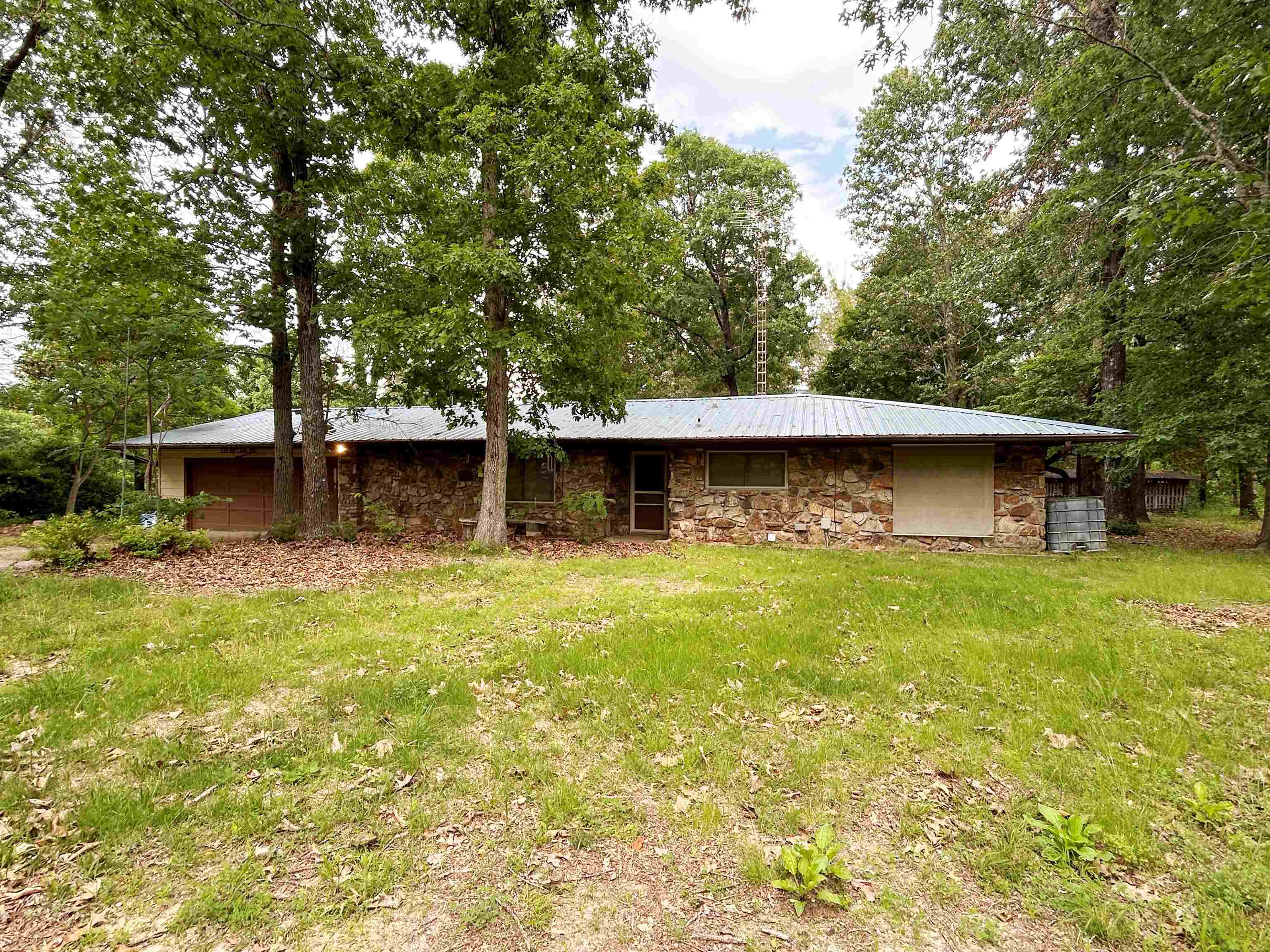 Look at this diamond in the rough! 38+ acres with a 2 BR 1.5 bath home with garage attached and a 30x50 shop with 2 overhead doors.  There are a couple more outbuidlings scattered around the property. Once was a gardener's dream, with lots of flower beds, fruit trees, garden spots that need revivied.  With a little TLC this would be a show place. Sitting on paved state highway is a definate plus.  Home is strategicly located down a long drive so is amost hidden from the road. Lots of large trees and timber on the property making it ripe for hunting and serenity. Minutes to Hardy, AR and Spring River.   Metal roof installed approx 2024, HVAC installed approx 2001, Just the second owner of the property, Shop has 2 over head doors approx 12 ft high, Storm shelter