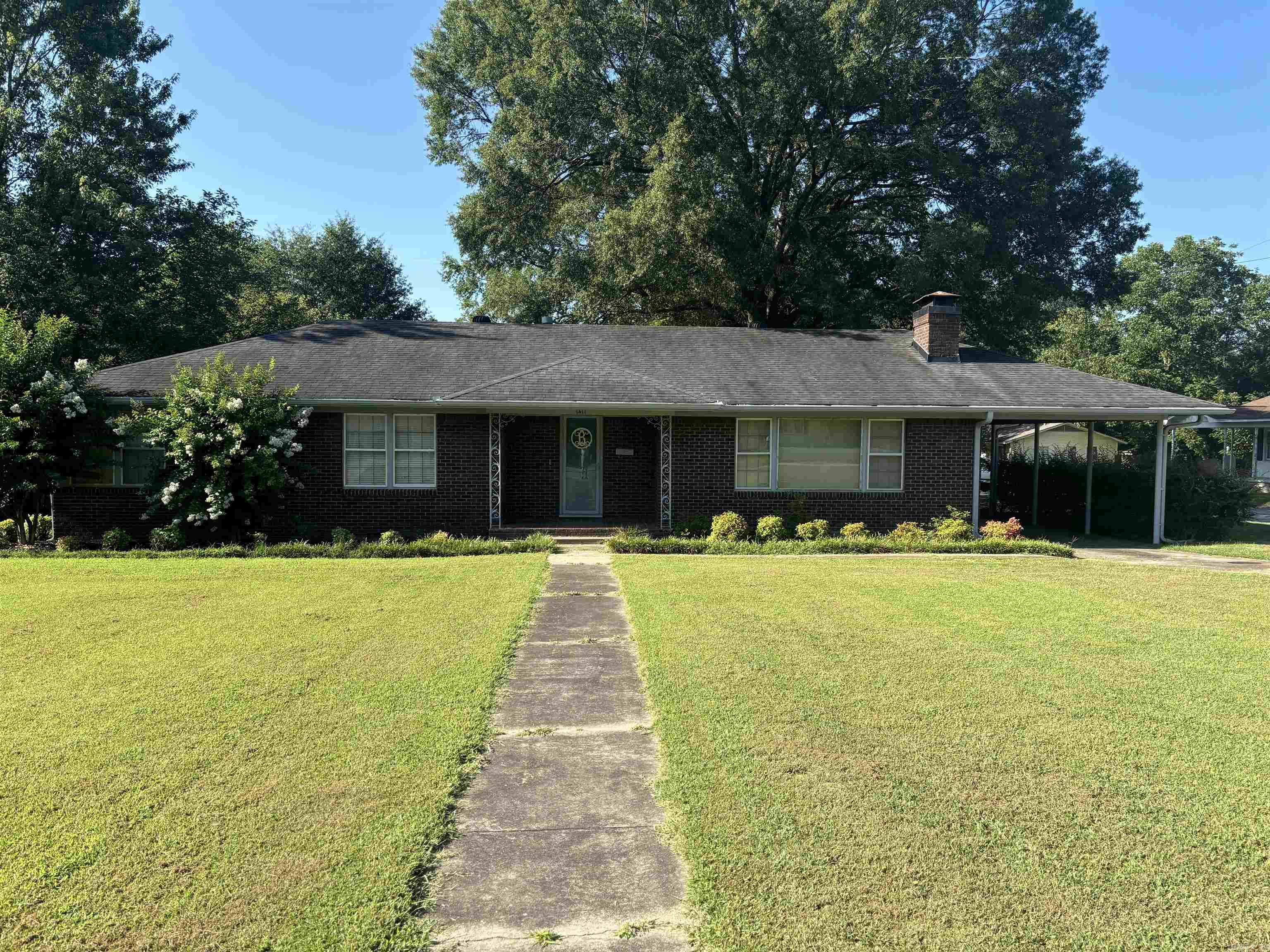 Nestled on a large corner lot, this mid-century modern brick home located on historic W. Arch offers original wood flooring and the perfect blend of classic design and contemporary updates. Located near all schools in Searcy with 3 bedrooms and 2.5 baths, this residence is ideal for families, Airbnb enthusiasts, or anyone who appreciates the elegance of vintage real estate. The drive-through carport adds more charm. Updates include a new roof in 2016 and HVAC in 2022. Enjoy the coziness of a wood burning insert in the fireplace. There is MORE! A shed and two RV hook-ups with concrete pads in the fenced back yard are perfect for housing extra guests. Experience the convenience of a newly added laundry room and various updates seamlessly integrated into the home’s original charm. Make your appointment today. This one won't last! See agent remarks for more information.