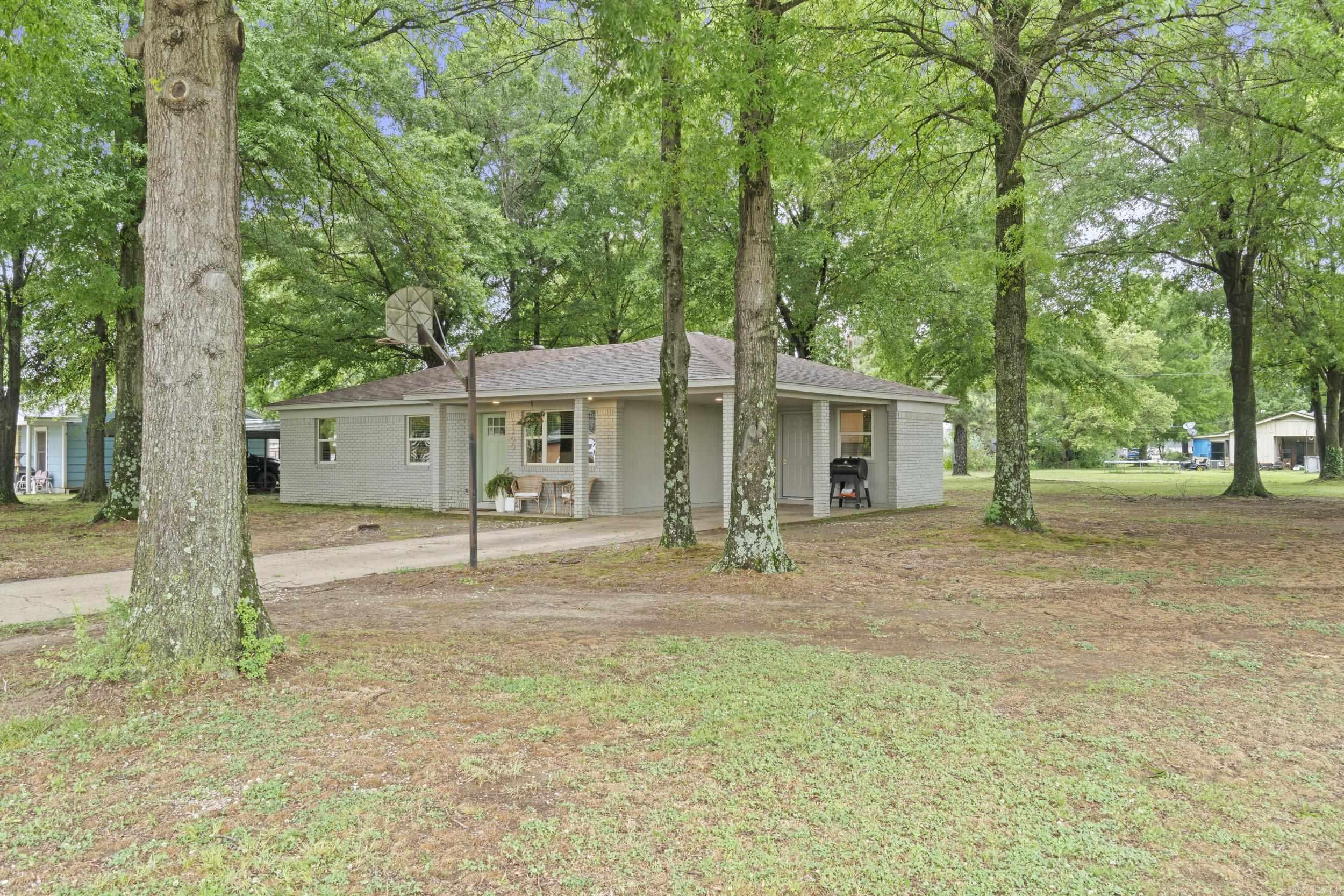 Completely updated and move-in ready! Why rent when you can own this charming 3 bed, 1 bath home situated on a large, tree-shaded corner lot within Wynne city limits in an established neighborhood? This property underwent a full remodel in 2024, including a new roof, windows, kitchen, bathroom, flooring, paint, and fixtures—offering peace of mind and modern style throughout. The living and dining areas flow seamlessly into a beautifully updated kitchen featuring new shaker-style cabinetry, quartz countertops, stainless steel appliances, and a refrigerator that conveys. The bathroom has been completely renovated with a tiled tub surround, updated vanity, and all new fixtures. Additional highlights include new flooring throughout, a spacious laundry room with extra storage, and energy-efficient upgrades that help keep utility costs low. Step outside to enjoy the generous yard space, perfect for relaxing, pets, or entertaining. The property also includes a covered carport and a frame storage building for added convenience. Don’t miss this budget-friendly, low-maintenance home—ideal for first-time buyers, downsizing, or investment potential!