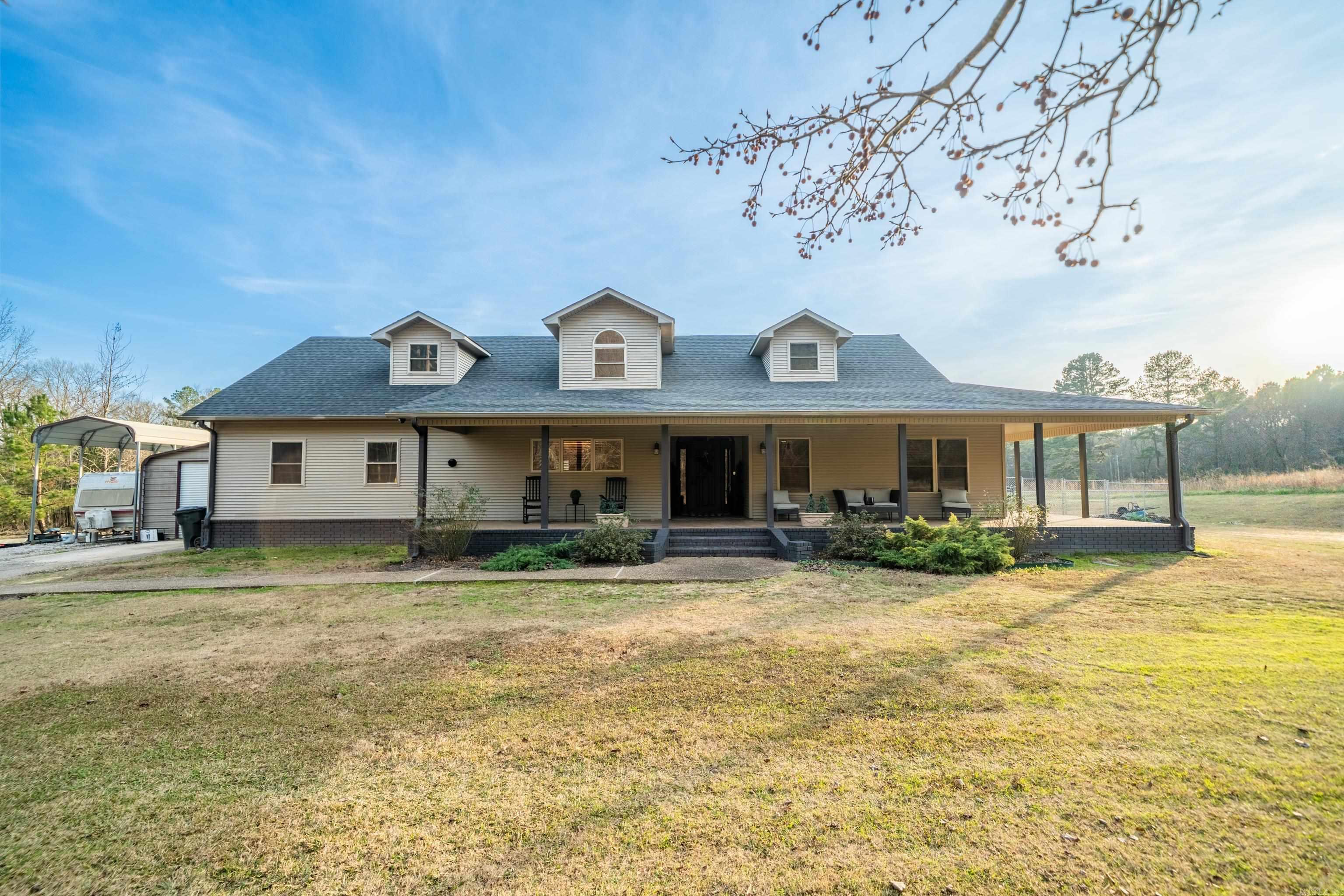 Stylish, classy, beautiful country living at its best! This is gorgeous home with 18' ceilings, customized concrete flooring, large rock fireplace, open floor plan on the inside, then opens up to a dreamy outdoor kitchen area with another fireplace and a tv for entertaining guest who can also enjoy the welcoming in-ground pool.  The detached heated/cooled garage is a perfect "man cave" for any car enthusiast to spruce up your classic beauty or to store your newest collection.  All of this sits on two spacious acres to enjoy any other outdoor activities or to park your boat or RV, close to Lake Hamilton school.