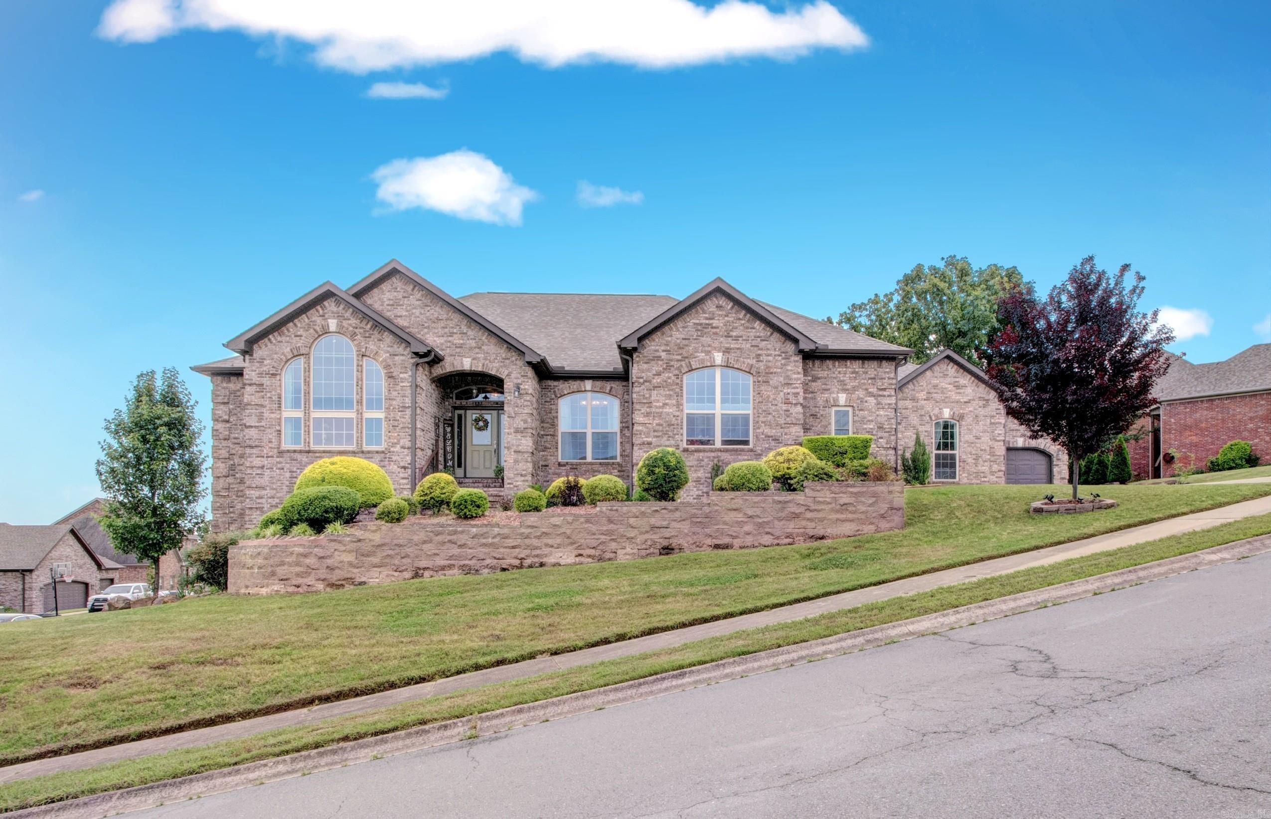 Discover unparalleled beauty in this stunning full-brick sanctuary. Situated on a meticulously maintained corner lot, this 4 bed 5 bath home boasts incredible curb appeal and thoughtfully designed split floor plan for ultimate privacy. The Primary Wing: your true retreat awaits featuring a spa like ensuite with elegant double tray ceilings, a walk in shower, double vanity, water closet, and expansive compartmentalized walk-in closet.   The Guest Wing: Designed for multi-generational living high end hosting, features a junior suite plus two additional bedrooms with a full shared bath. The Heart of the Home: A chef's dream kitchen built for gatherings complete with double ovens, a breakfast bar a charming breakfast nook all complemented by a dedicated formal dining room. Endless Space to Live & Play: Dual Living Spaces: sun drenched sunroom perfect for morning coffee. Second Floor Bonus Room: features a full bath perfect for a Cinema room, home gym, or secondary executive office- your dream option.  The basement is being used as a workshop but offers additional options. Located in a highly coveted neighborhood, this home is a rare find. Schedule your private tour. Agent remark