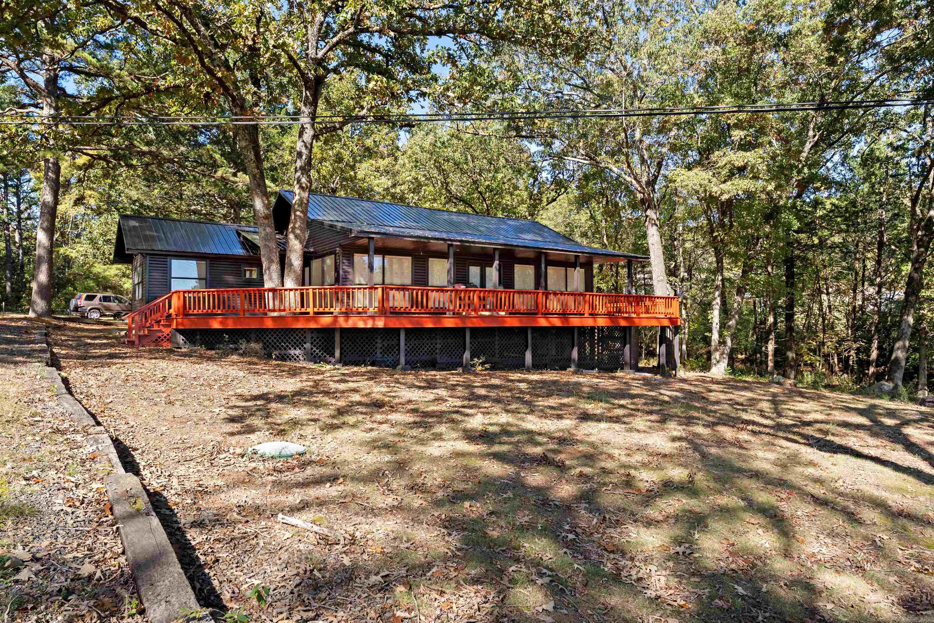 Great location near marina on Greers Ferry lake...1.3 acres with covered community boat dock.. ....Fairfield Bay address but no POA dues... furniture included in 137....covered decks with view of Greers Ferry lake and Sugarloaf Mountain....convenience of Fairfield Bay amenities within minutes...two built around mobile homes with permanent foundations square footage and primary information shown is 137....145 square footage is 851 with 2 bedrooms and 1 bath...great view of lake...all features do not apply to both homes....must see to appreciate...call listing agent for clarification of features...can be purchased with 135 Jay Tee...MLS # 26008815..
