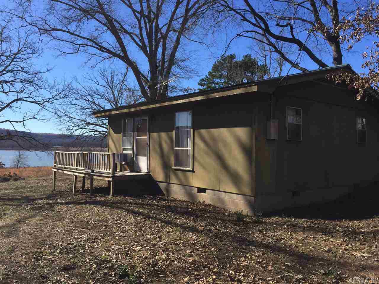 Two bedroom one bath bungalow with excellent lake view and access.  Large tree shaded lot gently slopes to the lake. With a little TLC this could be a great getaway! Only 5 minutes from Hwy 365. House to be sold AS IS.