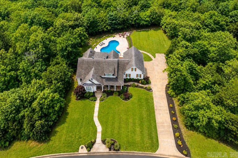 Welcome to this Southern Living style charmer!, This stunning 4-bedroom,4-bath home offers over 3,500 square feet of thoughtfully designed living space, surrounded by lush greenery that provides both privacy and serenity.  On the main level you’ll find a gorgeous primary suite complete with a spacious ensuite bath, as well as an office with beautifully vaulted ceilings, and a full bathroom.  The open-concept layout flows seamlessly, featuring a well-appointed kitchen, generous living room, and elegant dining spaces.  Upstairs features a bedroom with an ensuite bathroom, as well as 2 additional bedrooms and a fourth full bath.  You will love the bonus room that could be used as a home gym, media room, playroom, or 5th bedroom adding even more value and versatility to this exceptional property.  Outside you can relax in the in-ground pool nestled among mature greenery.  The expansive outdoor space is steps away from the fantastic outdoor amenities that Waterview offers!