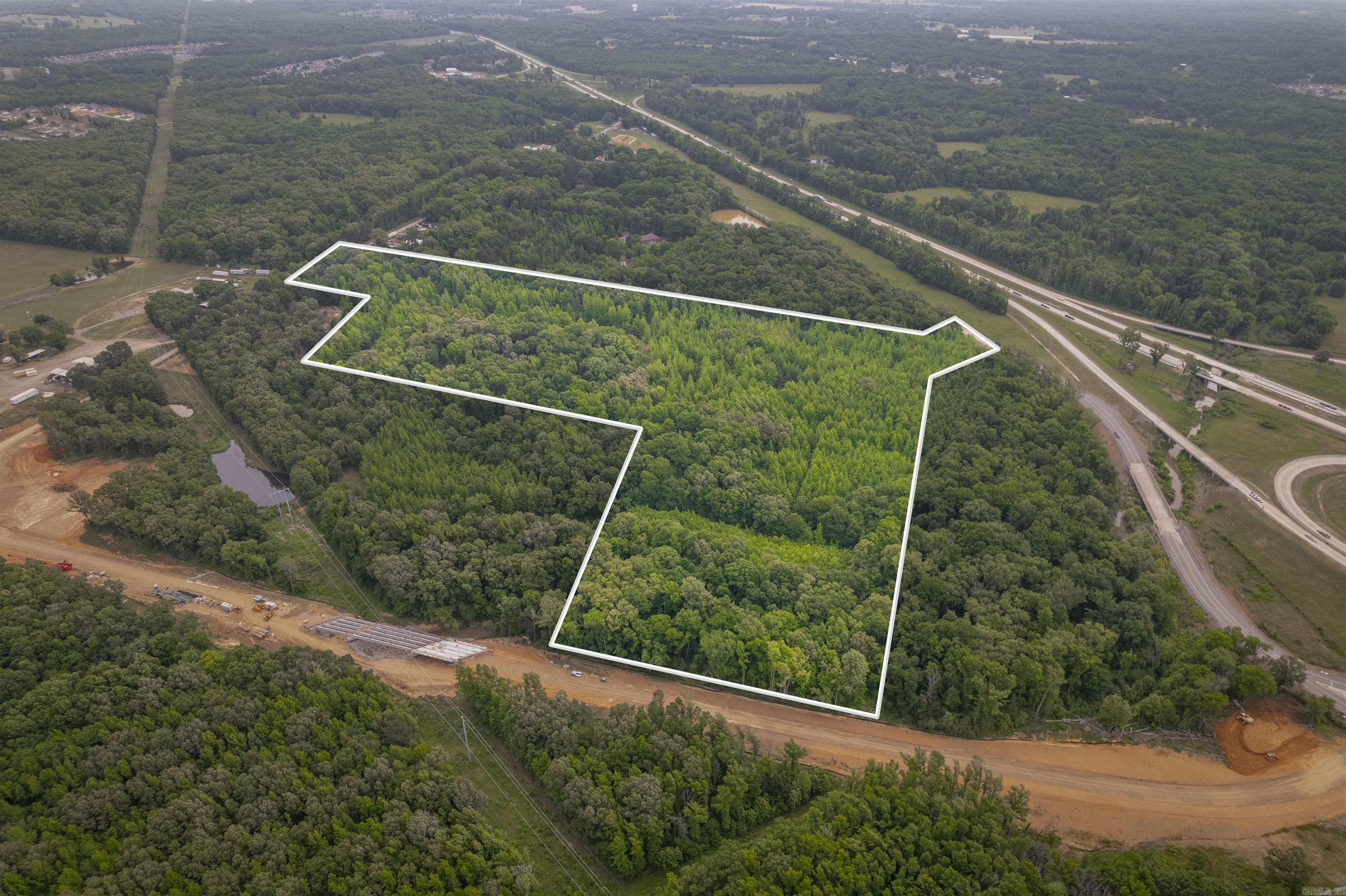 Significant Future Potential! Located primarily along the New Road (approx 650' of frontage) being added for the Lyon College Veterinary School, this property also has access from Ernie Davis (approx 200' frontage) and Willie Ray Rd (approx 100' frontage) too. This approx 33-Acre property has excellent marketing potential for building commercial structures such as Hotels, Apartments, Gas Stations, Shopping Centers, Multi-Use Property, Retail Locations, etc...Utilities located at roads. The property has great long-term potential. This property will be located on a very busy roads in the near future, that will provide service extending towards Cabot's Greystone, Austin's George's Crossing & Valley View subdivisions in Austin and more! This property has significant potential for an investor to turn this into a positive income producing property! The sketch shown here is not a Survey. An official Legal Description, Acreage and Dimensions shall be defined by a New Survey. SEE AGENT REMARKS.