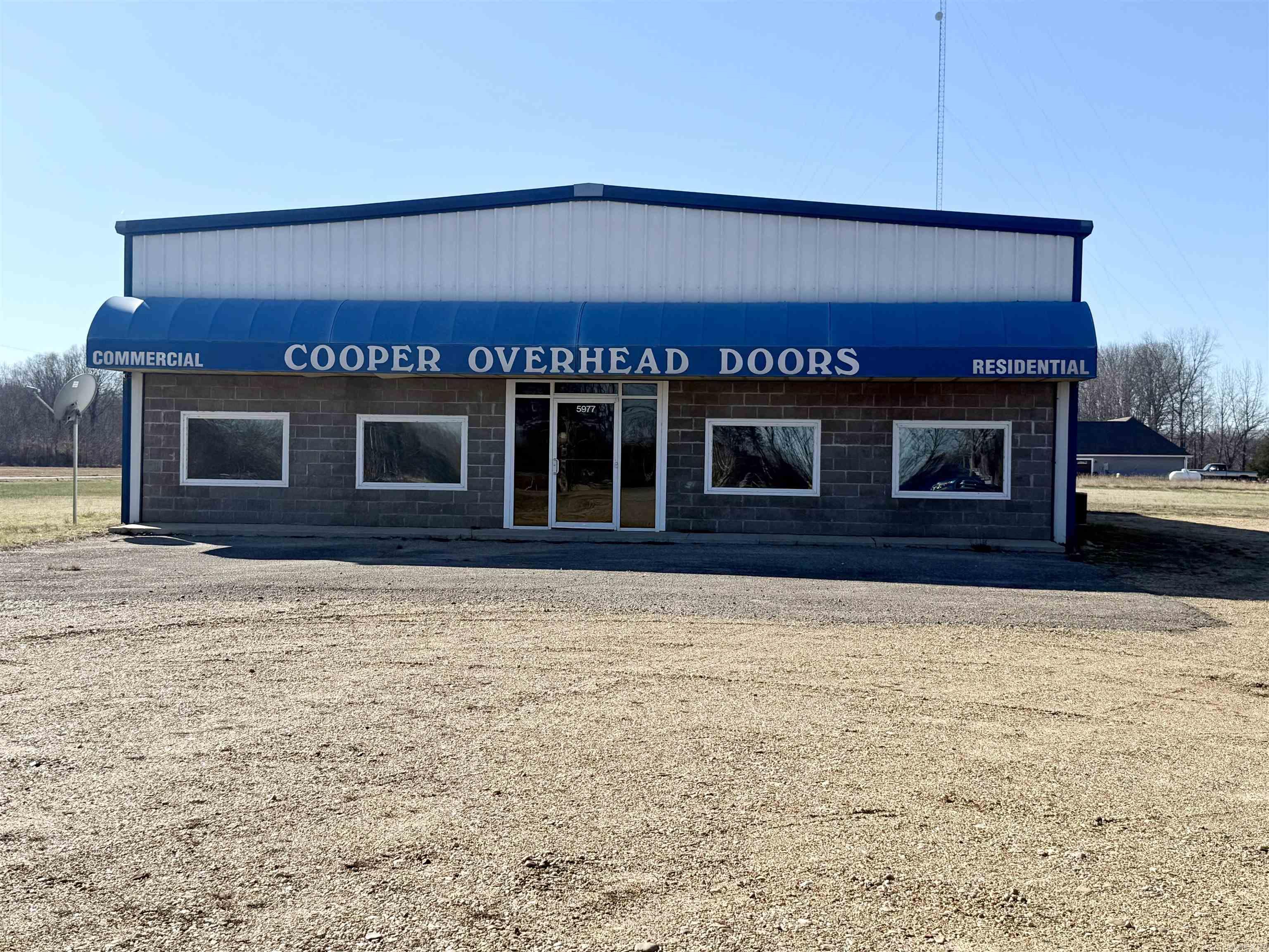 Position your business for success with this versatile commercial property situated on 2.76 acres and featuring two 5,000 sq. ft. buildings designed for efficiency and flexibility.  The primary building offers a spacious office area with a half bath, while the remainder is dedicated to warehouse/shop space with an additional half bath. Four overhead doors—two on each side—create an ideal drive-through layout, allowing large trucks and equipment to enter from one side and exit the other with ease. A covered front awning spans the width of the building and provides protected access directly into the office area, creating a welcoming and functional entry point.  The secondary 5,000 sq. ft. building includes two overhead doors and offers excellent additional storage, workspace, or expansion potential.  With ample parking, generous green space, and room for future growth or outdoor operations, this 2.76-acre property is well-suited for logistics, construction, service businesses, or light industrial use.  Owner is also willing to lease the property at $5500 monthly.