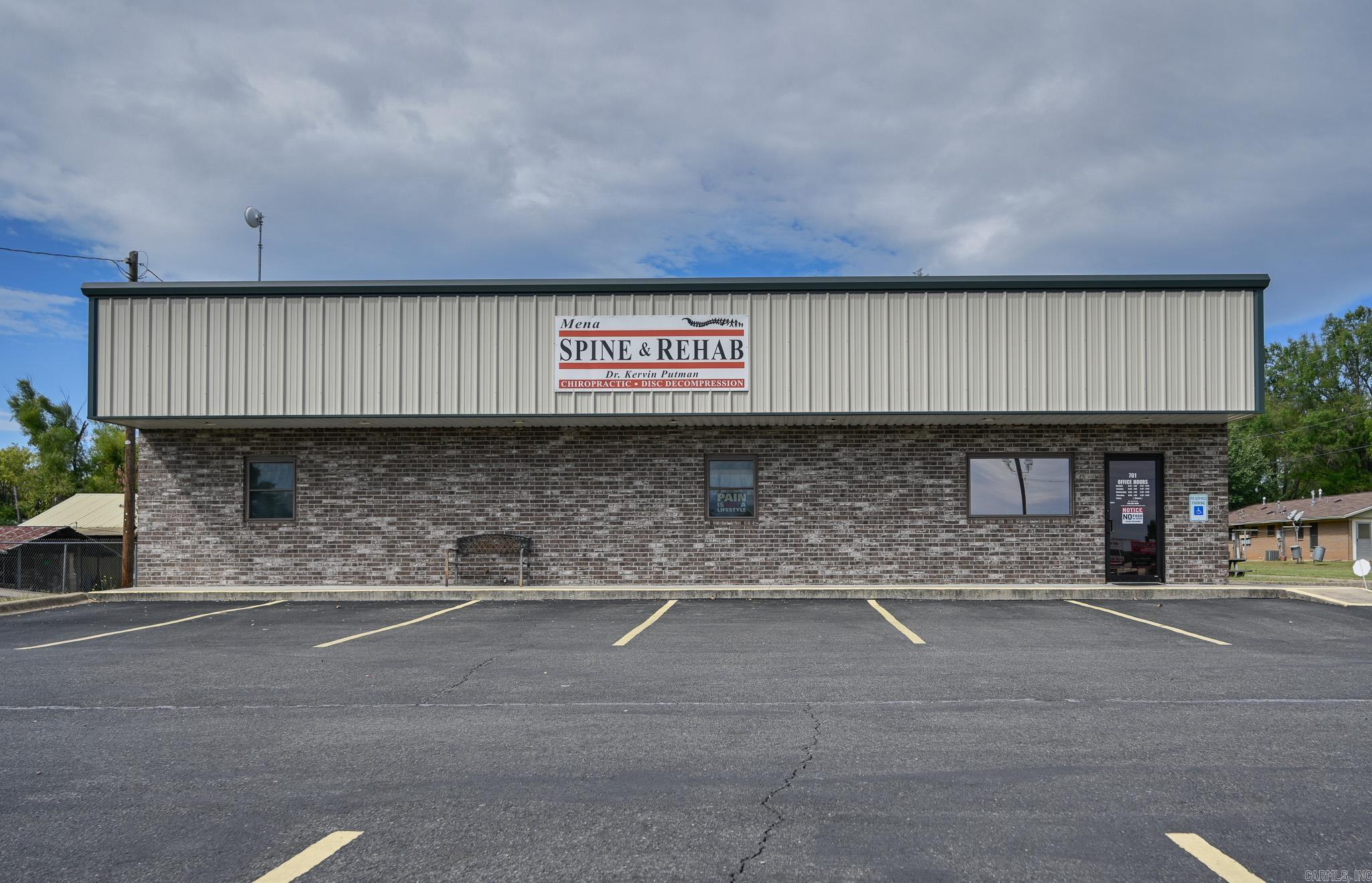 This commercial business location is in a highly visible and densely populated area of Mena, making it ideal for your new venture. The .32 acre property is complete with lighted signage, asphalt parking lot, and landscaping. The main feature is an immaculately kept 32x60 steel building with awning and a brick face. Superior soundproofing with spray foam insulation on the exterior walls and fiberglass inner insulation contributes to peace and quiet in this well-insulated space. Inside you will discover a reception area, kitchen, large open floor space, 4 rooms with sinks, an office room that includes a full bath with walk-in shower, plenty of storage, utility space with washer/dryer hook-up, security system, and energy-efficient LED lighting throughout.