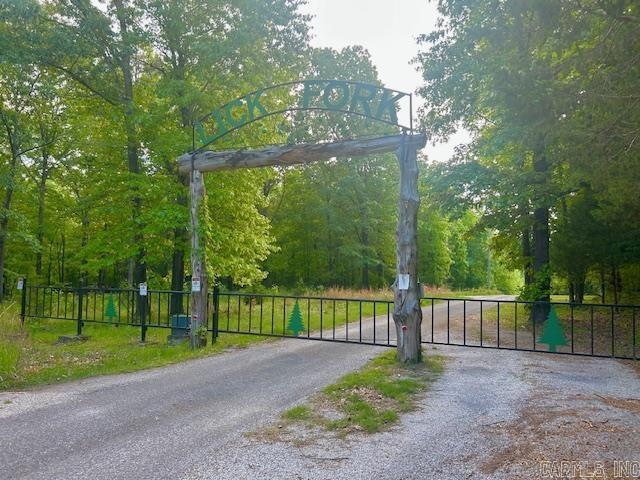 Your Ozark retreat awaits!!! This 3.35 acre lot m/l is tucked inside a beautiful gated subdivision just minutes from downtown Mountain View, AR-- known as the Folk Music Capital of the World. Enjoy live music on the courthouse square, float or fish for trout on the nearby White River, and take in the peaceful beauty of this serene setting. The property offers privacy, creek access just down the road and the protection of thoughtful restrictive covenants to preserve the charm and value of your investment. Come  build your dream where ,nature, music, and small town charm meet.