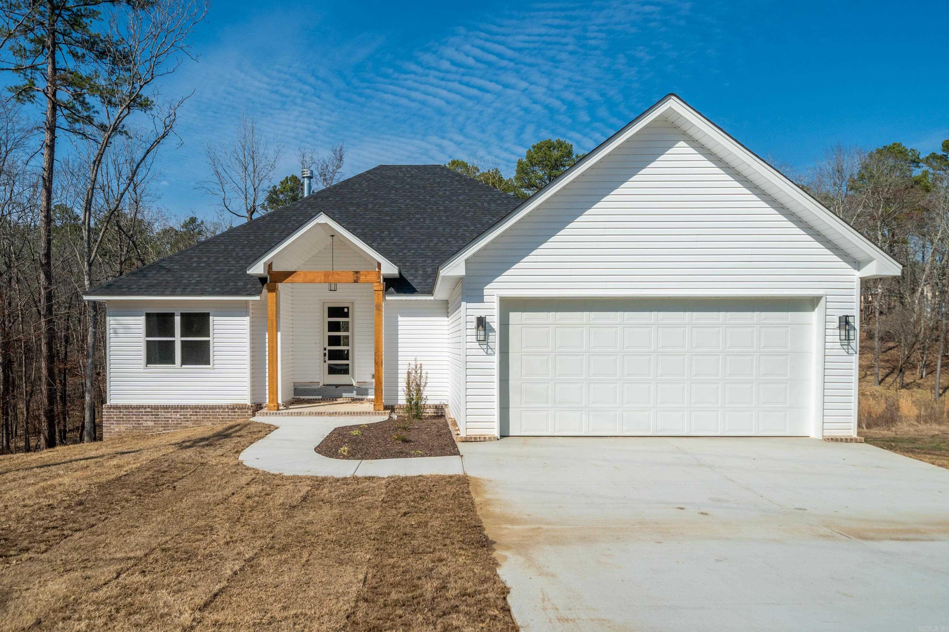 This 4 bedroom/ 2 bathroom new construction home in Diamondhead Gated Community is complete and ready for a new owner! This open concept layout with luxury laminate flooring throughout the home means easy maintenance --no carpet! Enjoy your stunning kitchen with walk-in pantry, beautiful quartz countertops, prep island w/sink, stainless steel applainces, & built in microwave. The main area has 10-foot ceilings along with a fireplace and captivating views from the back windows for an open, airy feeling. A covered deck allows for outdoor entertaining, plus a lower concrete pad could be a great hot tub spot. The master suite includes dual sink vanity, walk-in shower, separate soaking tub, & large walk-in closet that leads to the laundry room. Laundry is also accessible from the mudroom as you enter from the garage.  With a golf course and Lake Catherine access in the neighborhood, the large storage area under the back of the house is a bonus for all your toys. POA amenities include gated entrances, clubhouse with large meeting room, library, bar & grill, private roads, swimming pool, basketball, tennis & pickleball courts, park with pavilion, fire pit, disc golf course and playground.
