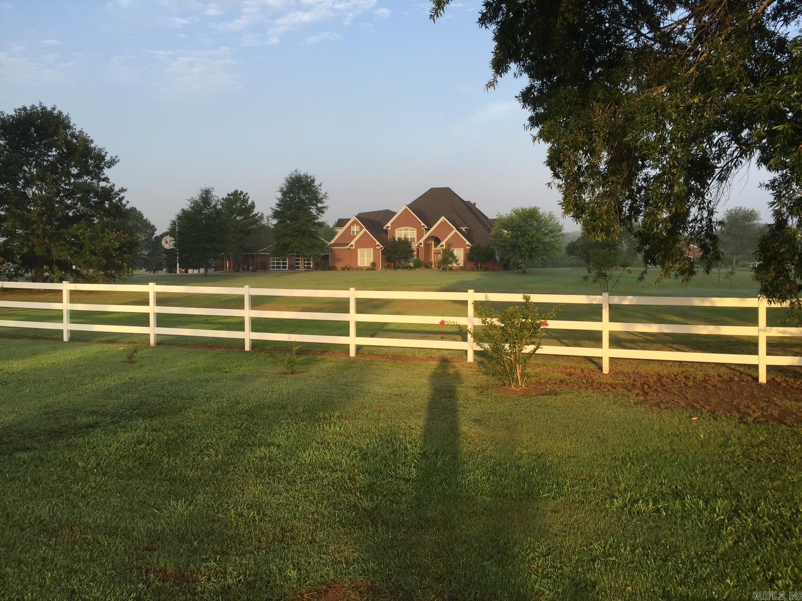 By appt only. Large house, two complete kitchens + kitchen in shop, heated floors, upstairs refrig & W/D stays, 3 living rooms 2 w/built ins, a complete 12 person theatre w/Denon, Epson,& Klipsch, small library, a big game room w/ 2 game closets, big seasonal closet, a third floor craft/sewing room, balcony overlooks back yard pond w/pavilion & year around flowing creek, each bedroom has its own bath +two 1/2 baths. House has 4 car garage +4 wheeler parking area. Portico attaches house & working shop w/8200 Sq. Ft, HVAC, has kitchen and full bath, showroom, shop, MH garage, warehouse & parts room. Greenhouse is 25' X 34', has running water and heat.  Accessory bldg is 25' X 34' w/separate storage area for tractors, etc.,can convert to guest house. 6 acres in city limits, not in a subdivision. 7 HVAC units + 2 gas heaters, 11 garage doors. Lots of trees, white vinyl fence on front. New roofs 2024. Lots of other features not listed here. Call for list of items that do not remain.