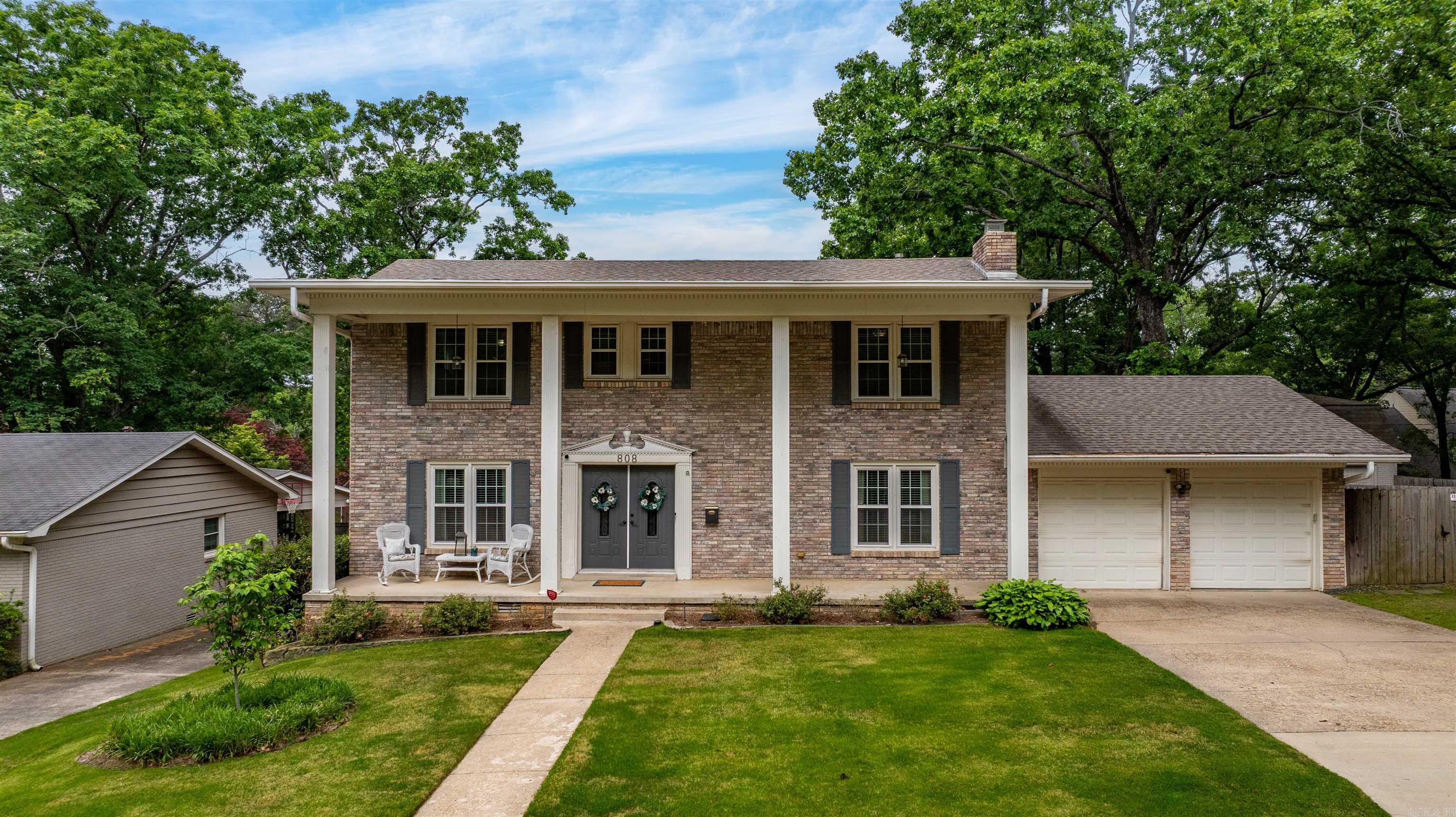 Traditional move-in ready home in the heart of Leawood with an incredible backyard and fabulous pool! The main level features a spacious den/living room, separate dining room with fireplace and built-ins (could be used as second living area), updated eat-in kitchen (w/ stainless appliances & built-in desk area), plus laundry and half bath. Upstairs, the oversized primary suite offers two closets and an updated bathroom, along with three additional bedrooms and hall bathroom.  The backyard is perfect for entertaining or relaxing and includes a pool with diving board and slide, covered patio, beautiful landscaping and fully fenced backyard. Additional features include a two-car garage with large storage room, hardwood floors, newer carpet & more! Wonderful curb appeal and great location convenient to shopping, dining and hospitals! Roof 2019. Upstairs AC 2024.