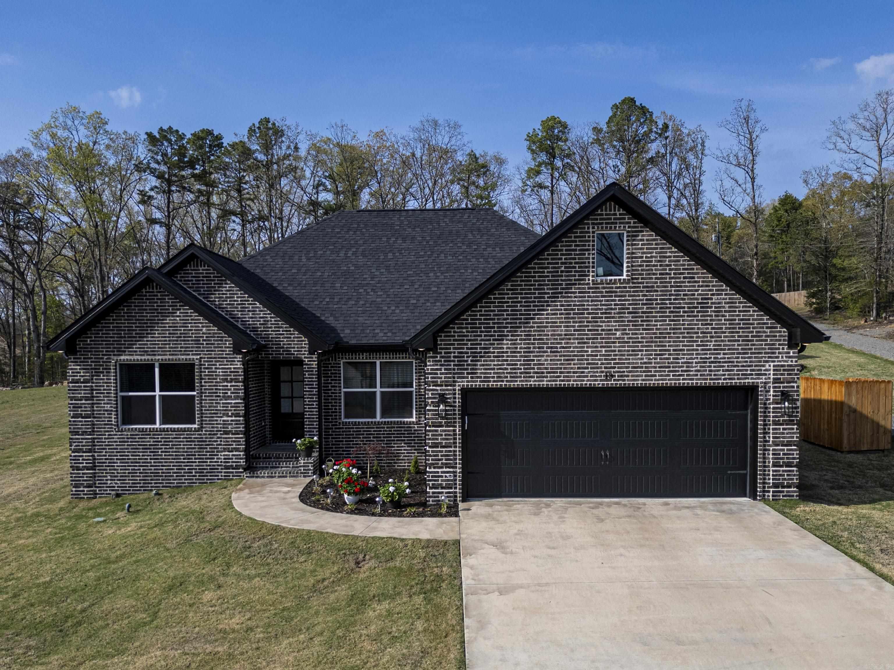 Experience the perfect blend of modern comfort and outdoor recreation in this beautifully crafted 3 bedroom, 2 bath home in the highly sought-after Little Red River Estates. Built in 2023, this thoughtfully designed home features an inviting open floor plan where the spacious living room, highlighted by a gas-log fireplace, flows seamlessly into the kitchen—creating an ideal space for entertaining family and friends. Step outside to enjoy the covered back patio overlooking a privacy-fenced backyard, offering plenty of room to relax, grill, or unwind. A standout feature is the impressive 16x50 brick RV carport, designed to complement the home, along with an attached shop complete with 50-amp service for hobbies, storage, or your outdoor equipment. Residents of Little Red River Estates enjoy access to a private community boat dock and boat slip, making it easy to spend your days fishing, boating, kayaking, or simply taking in the beauty of the Little Red River. Conveniently located just minutes from downtown Heber Springs and Greers Ferry Lake, this home offers the best of peaceful neighborhood living with endless opportunities for outdoor adventure right at your doorstep. Remarks