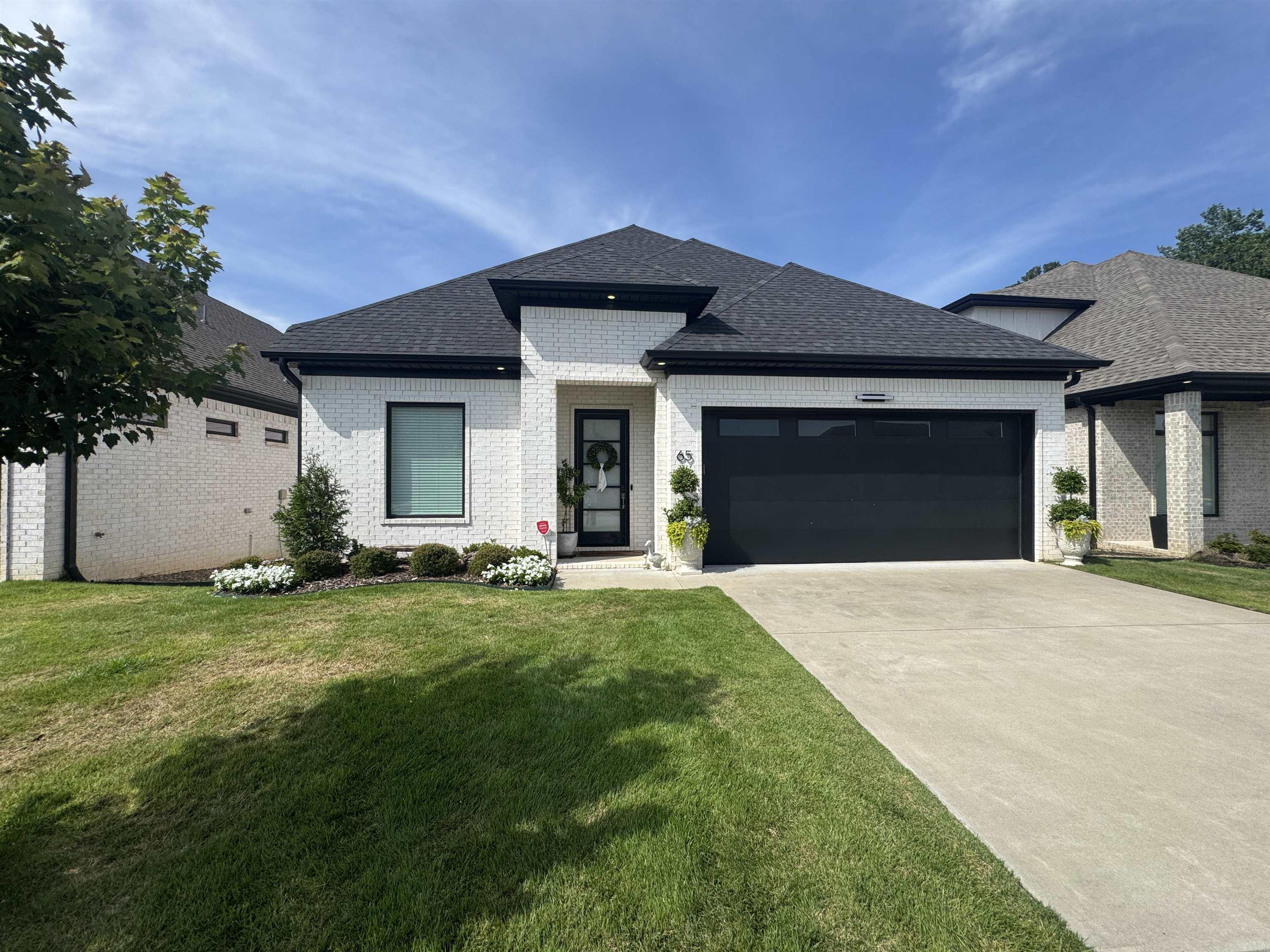 Gorgeous open floor plan, high ceilings and ample room to spread out for the entire family. Hardwood floors, custom cabinetry, large windows, tons of storage and wide  open spaces make this beautiful home inviting for all. Enjoy entertaining in this well thought out 4 bedroom 3 full bath house with an open floor concept in the common areas leading to a covered back patio area overlooking a privacy fenced in yard backing up to mature trees. No need to worry about yard work with the POA fees covering front and back. So keep the sprinkler system going to keep the grass as thick as needed!