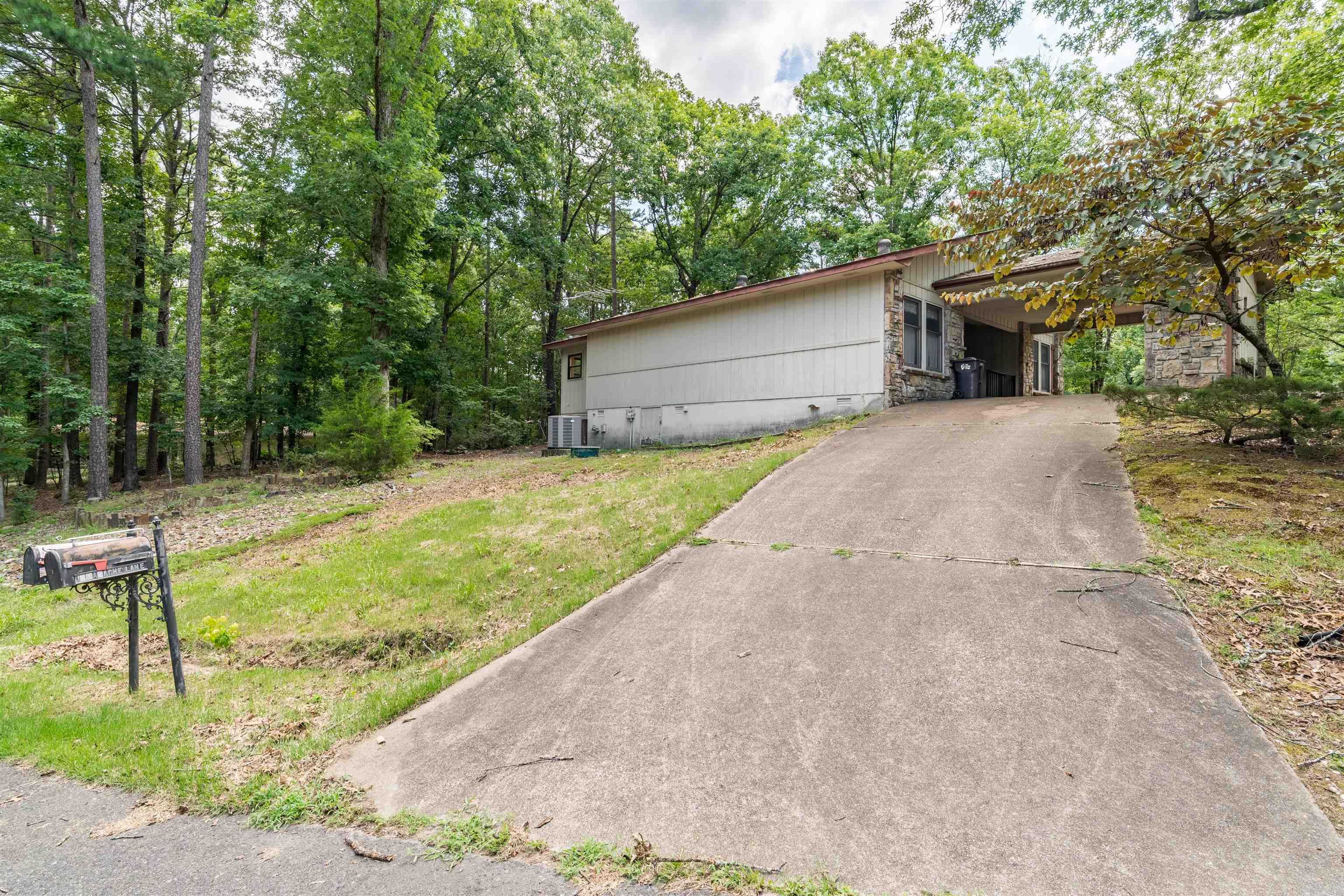 Located in the heart of Hot Springs Village, this well-maintained home offers a comfortable layout and a convenient location to enjoy everything the Village has to offer. Situated on a corner lot, it features a welcoming living area centered around a cozy wood-burning fireplace, while the sunroom provides the perfect spot to enjoy your morning coffee, unwind with a good book, or simply take in the surrounding views.  Its central location makes everyday living easy, with the Coronado Fitness Center less than 10 minutes away and every golf course in Hot Springs Village within a 15-minute drive. Lakes, walking trails, restaurants, and other Village amenities are all just minutes from your doorstep.  Whether you're looking for a full-time residence, a weekend getaway, or an investment opportunity, this home offers comfort, convenience, and the opportunity to enjoy the Hot Springs Village lifestyle.