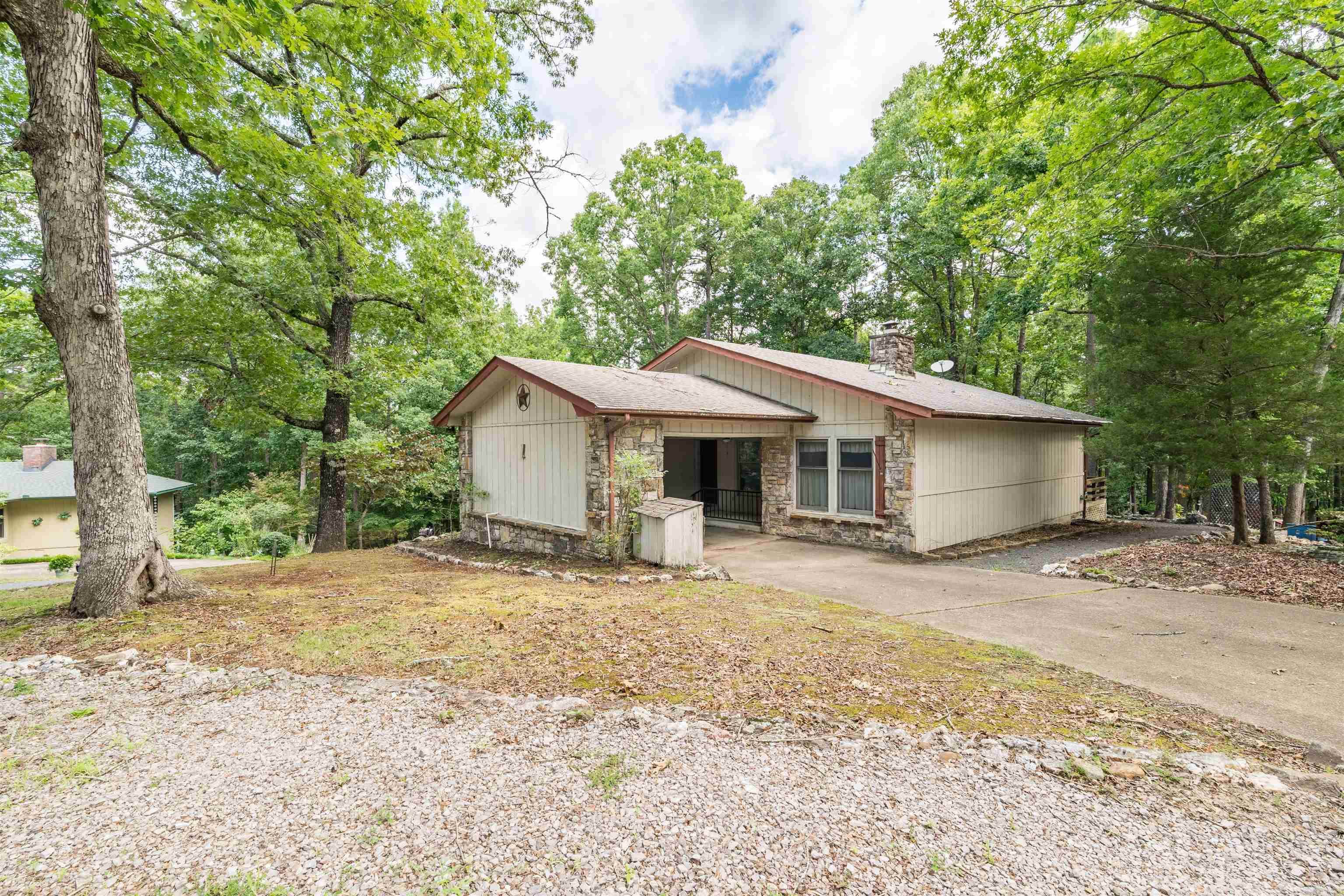 Located in the heart of Hot Springs Village, this well-maintained home offers a comfortable layout and a convenient location to enjoy everything the Village has to offer. Situated on a corner lot, it features a welcoming living area centered around a cozy wood-burning fireplace, while the sunroom provides the perfect spot to enjoy your morning coffee, unwind with a good book, or simply take in the surrounding views.  Its central location makes everyday living easy, with the Coronado Fitness Center less than 10 minutes away and every golf course in Hot Springs Village within a 15-minute drive. Lakes, walking trails, restaurants, and other Village amenities are all just minutes from your doorstep.  Whether you're looking for a full-time residence, a weekend getaway, or an investment opportunity, this home offers comfort, convenience, and the opportunity to enjoy the Hot Springs Village lifestyle.