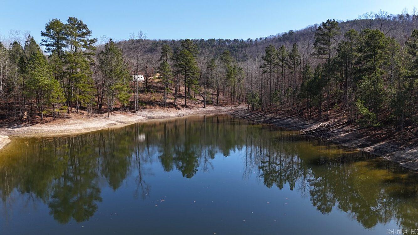 Discover the endless possibilities on this stunning 7-acre property on Walnut Valley Rd. Featuring a peaceful pond and multiple level build sites, this land is perfectly suited for one dream home or several cabins with beautiful mountain views. With no restrictions, you have the freedom to develop exactly what you envision, whether for personal use, short-term rentals, or a multi-cabin retreat. Located just five minutes from the roundabout, this property offers exceptional convenience with quick access to Hot Springs and the Village. A well is already on site, adding immediate value and saving on upfront costs. The property also includes a partially constructed home, providing a head start for those looking to complete or repurpose the existing structure. OWNER FINANCING AVAILABLE! Private, scenic, and ideally located, this is a rare opportunity to own versatile acreage with infrastructure already in place. Bring your vision and make it your own.