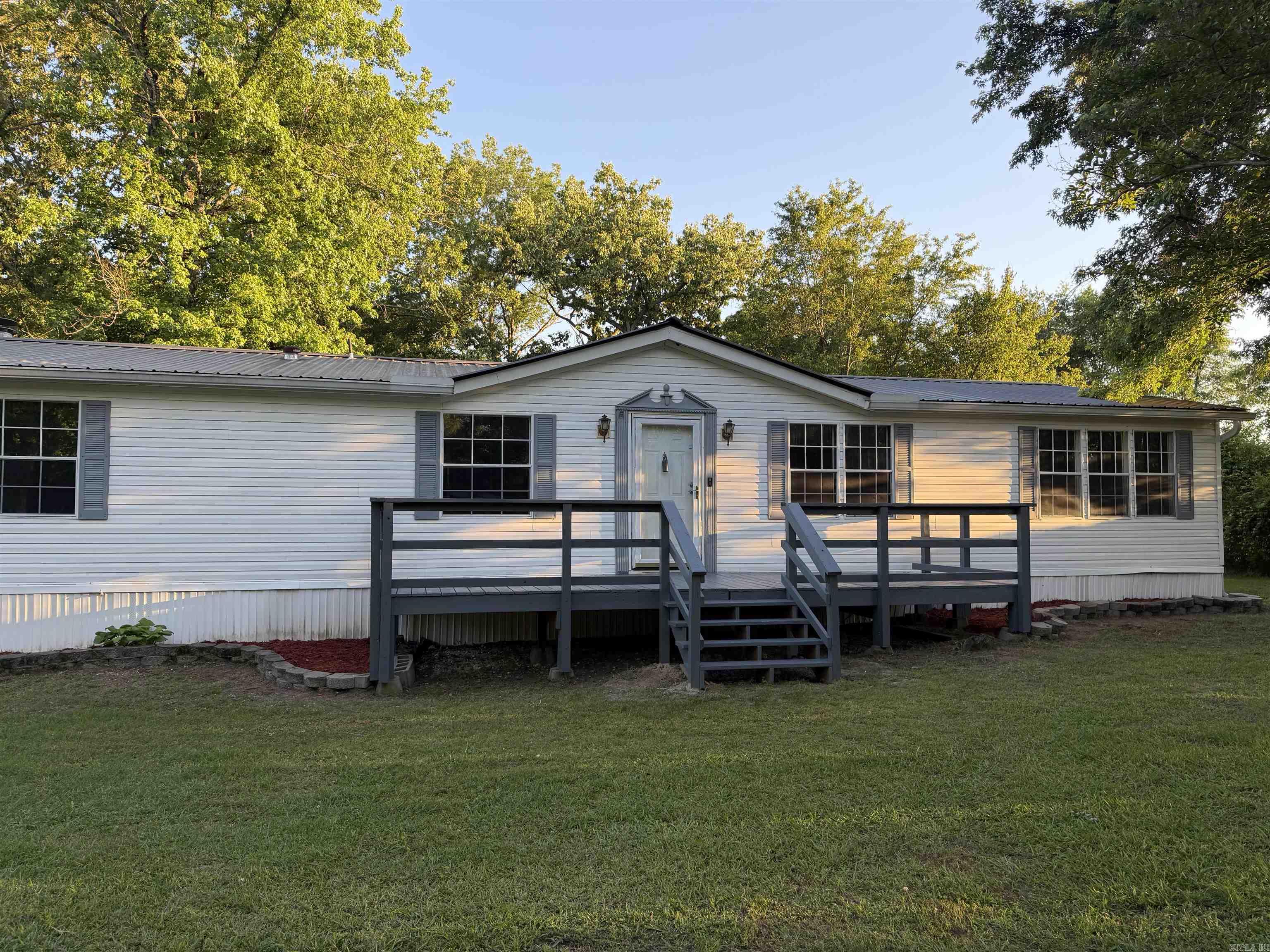 MOTIVATED SELLERY!!! Move in ready. You'll be amazed with this home with all the custom cedar woodwork. Large living room with an office space/nursery off the LR & primary suite. Speaking of the LG primary suite; the bath has double vanities, walk in shower & soaking tub. Off the kitchen is a hearth room with wood burning FP. You'll have 2 bedrooms joined by a full bath plus a guest suite. Don't miss the large laundry room. Detached 24 x 24 garage/shop and large decks on front & back on a dead end road. Bryant schools   Seller will install a Permanent Foundation with acceptable offer