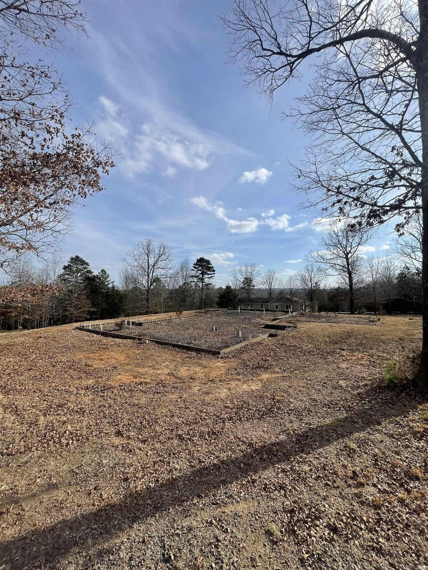 Looking to build a home? This property is ready for the new owners to step in and finish it to their exact style by customizing finishes, layout details, and design elements from the ground up. Some of the work is already done for you on this 8.11 acres in the Hawks Point Subdivision. Sellers have the plans. The footings have been poured, septic installed, already plumbed. Circle driveway. Water and electric at the road. Temporary power pole on site. Taxes TBD. Skip the early groundwork and bring your vision to life.