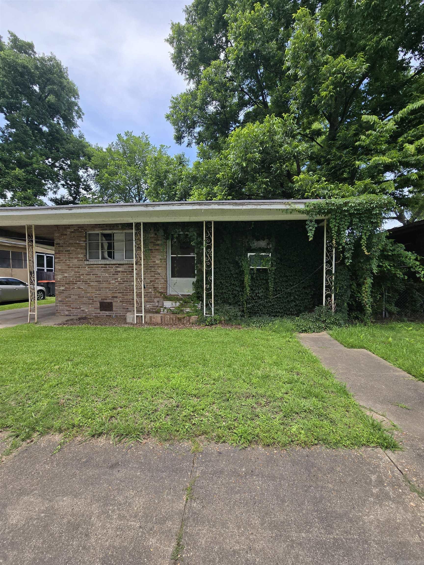 Brick Home Seeking New Owner: Loved by one family for decades, hoping to find a new owner willing to restore the pride of homeownership.  Needs a new roof and some updates.  Original hardwood floors, wood kitchen cabinets, with an attached carport for easy access during the rain. Nice-sized yard with great neighbors.
