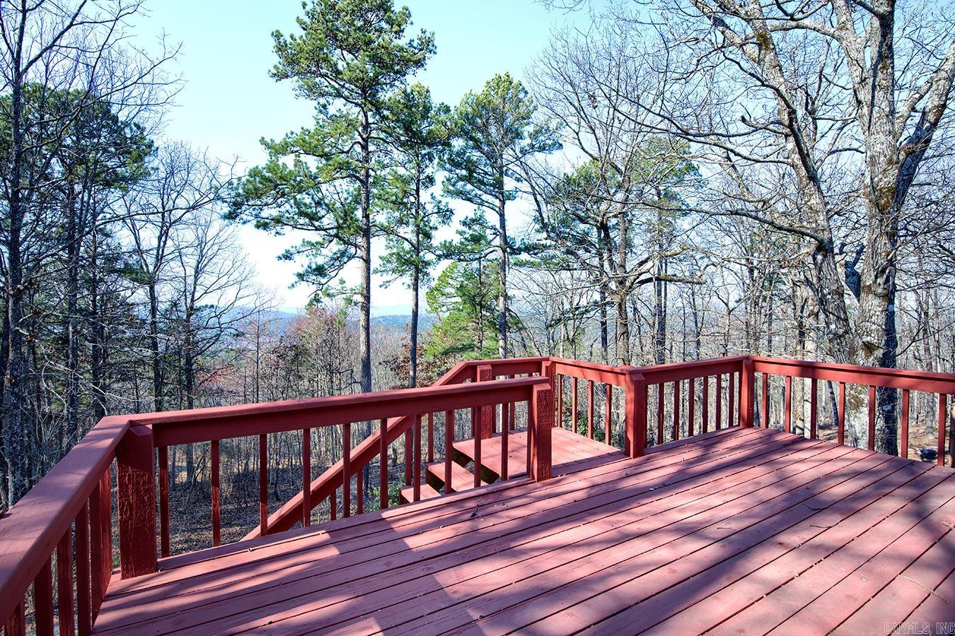 Peaceful Mountain View!!  This 2060 square foot 2-level home, with a breathtaking mountain vista, is perfect for multi- generational living, entertaining guests, or simply having ample space for hobbies, fitness/entertaining area, AND extra rooms for overnight guests. Custom built and very well maintained with new Anderson windows and vinyl siding in 2021, leaf filter screens in 2018, new garbage disposal in 2022. Featuring a large kitchen with pantry and abundant cabinetry, a welcoming great room, cozy woodburning fireplace, half bath, and primary suite on the main level. Two guest rooms, a full bath, and a bonus room with wet bar create endless opportunities for your creativity on the lower level. A separate heated and cooled workshop/storage room is an added bonus to your mountain retreat! Enjoy the relaxing, beautiful vista view from the expansive deck or the patio level.(Please be sure to view the virtual tour for the 360 degree tour of this beautiful home.)