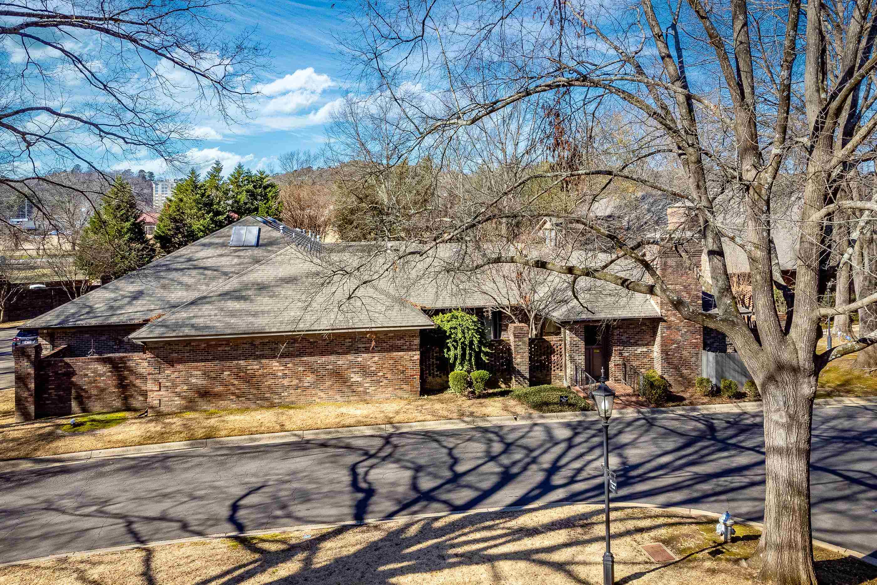 Beautiful one level condo in the very desirable private sanctuary of RIverbend. Open the outer door to a lovely courtyard leading to the front door.  Light floods the large living area with hardwood floors and a fireplace. Kitchen has a breakfast area, lots of cabinet storage and an island with cooktop. A skylight adds natural light. Hallway with floor to ceiling windows leads to 2 bedrooms.  Primary bedroom has an ensuite bath with a jetted tub and separate shower.  Hall bath has a walk-in cedar closet.  There is a separate office area.  Newer HVAC, approx. 5 years old. New carpet and freshly painted. Move in condition. Luxury living